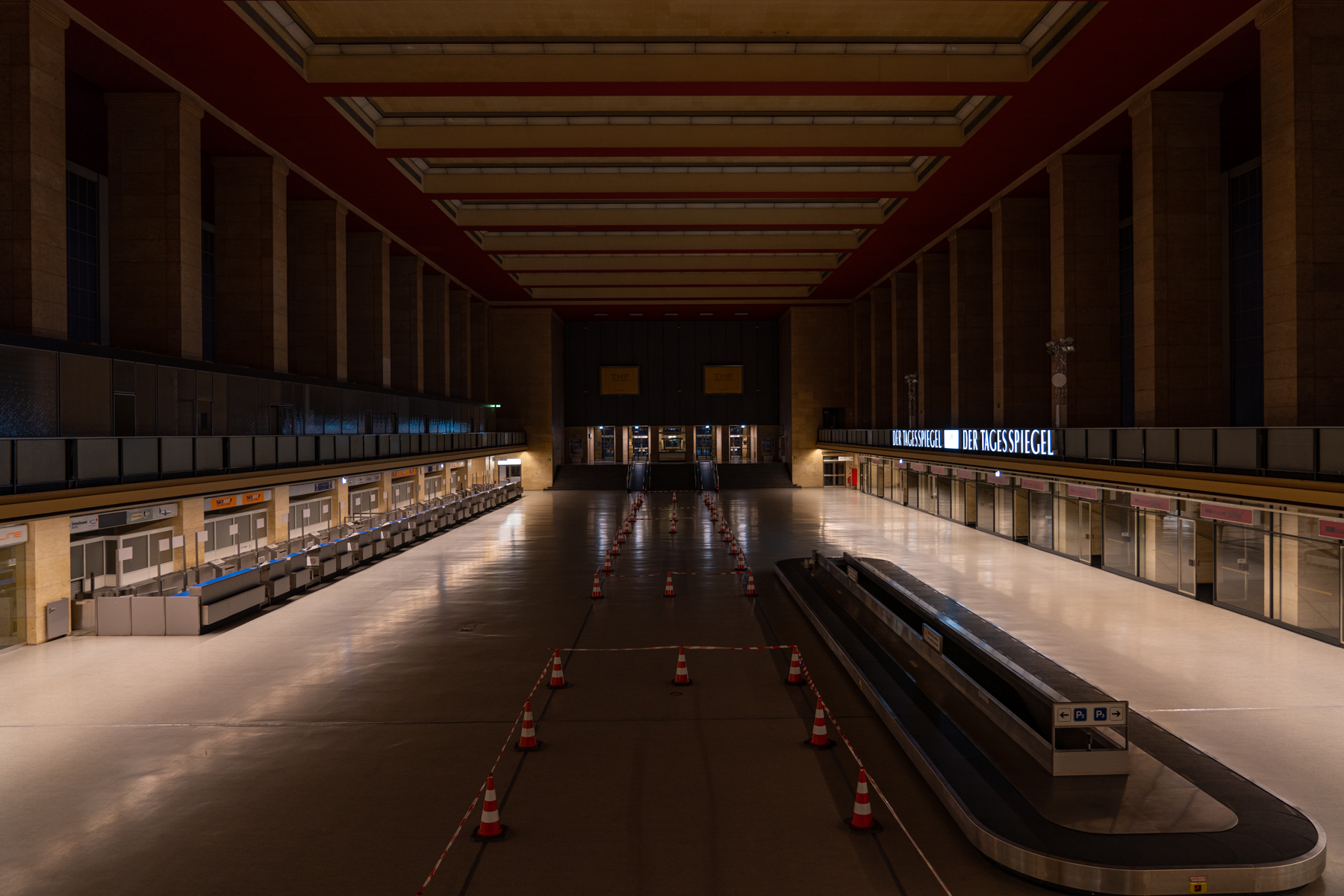 A deserted check-in and bagagge claim area at Tempelhof Airport.