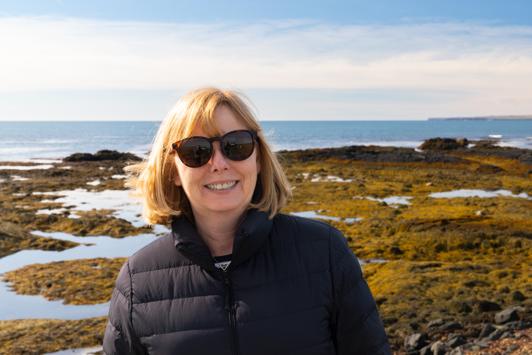 Andrea on the rocky coast where Strandarkirkja is built.