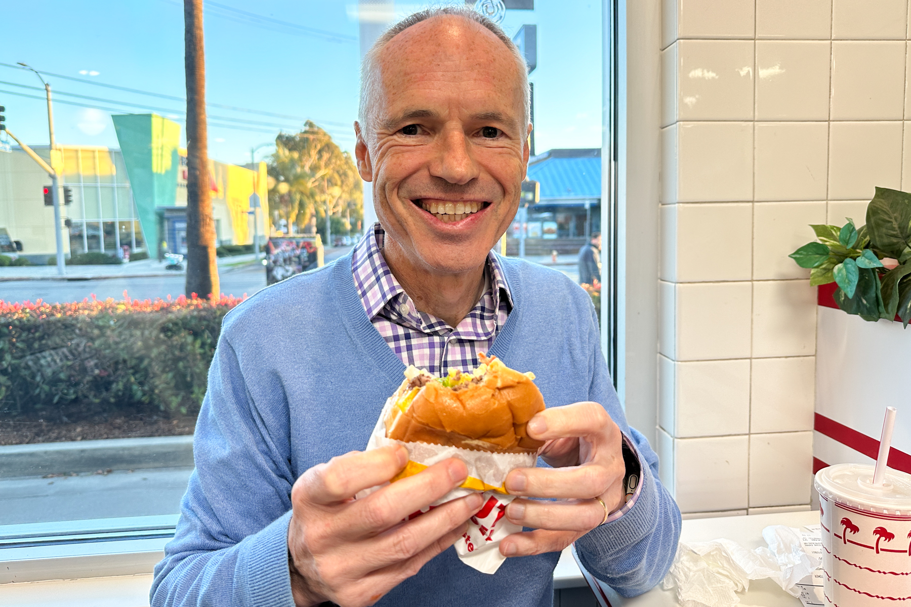 Keith enjoying a cheeseburger.