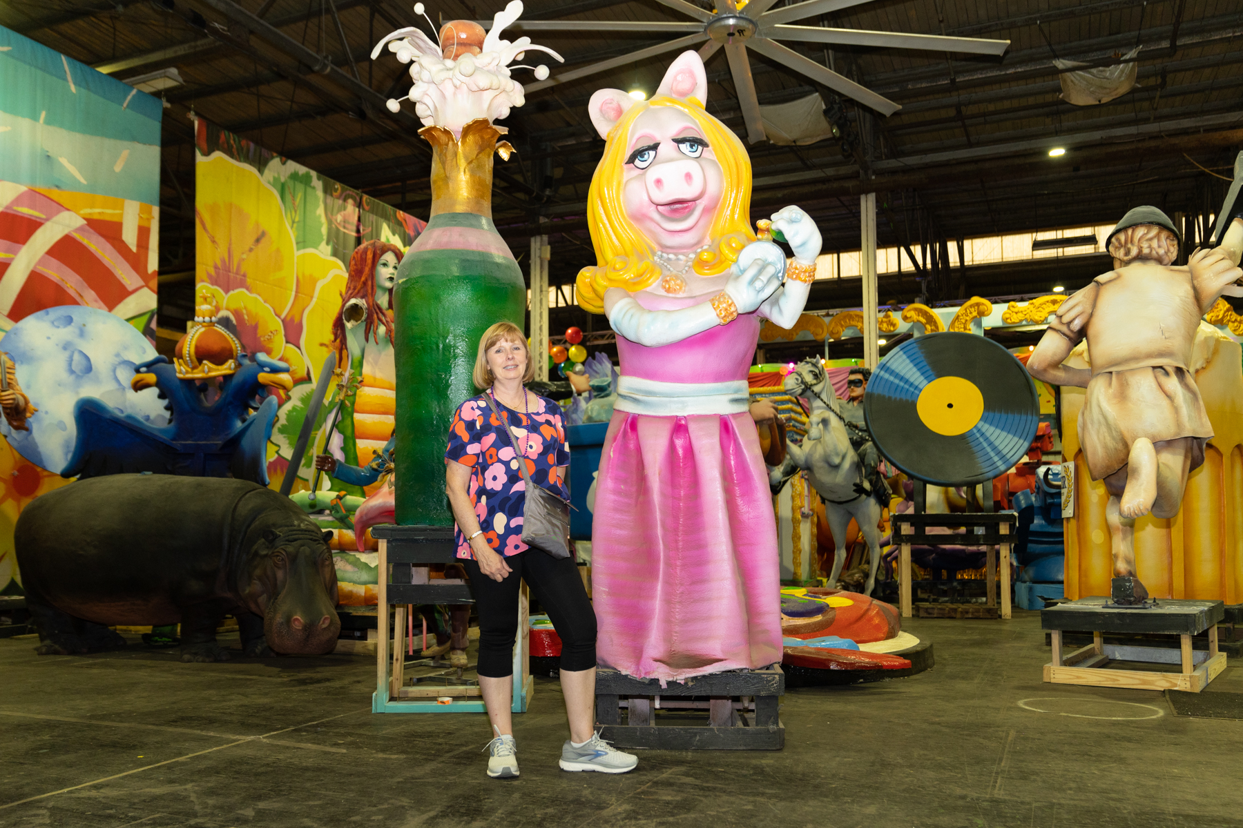 Andrea with some of the props at Mardi Gras World.
