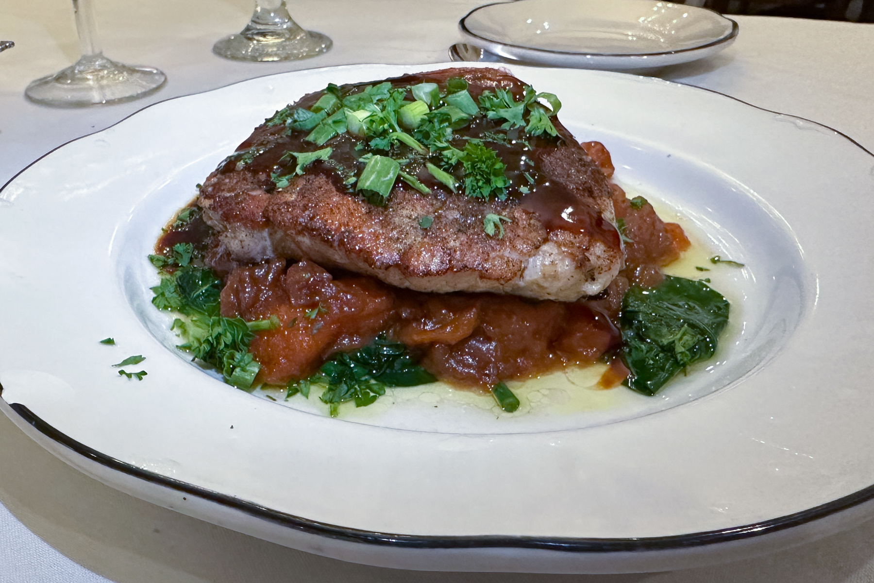 Pork sirloin with sweet potato puree, candied pecans, rapini, and Louisiana cane syrup.