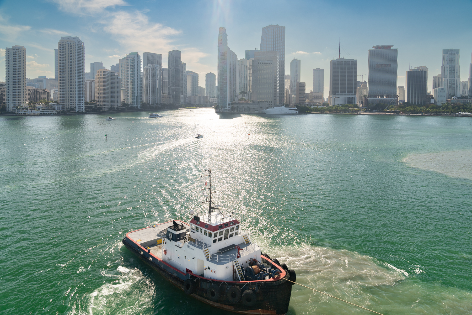 Our tug boat, pulling us away from the dock, with Miami in the background.