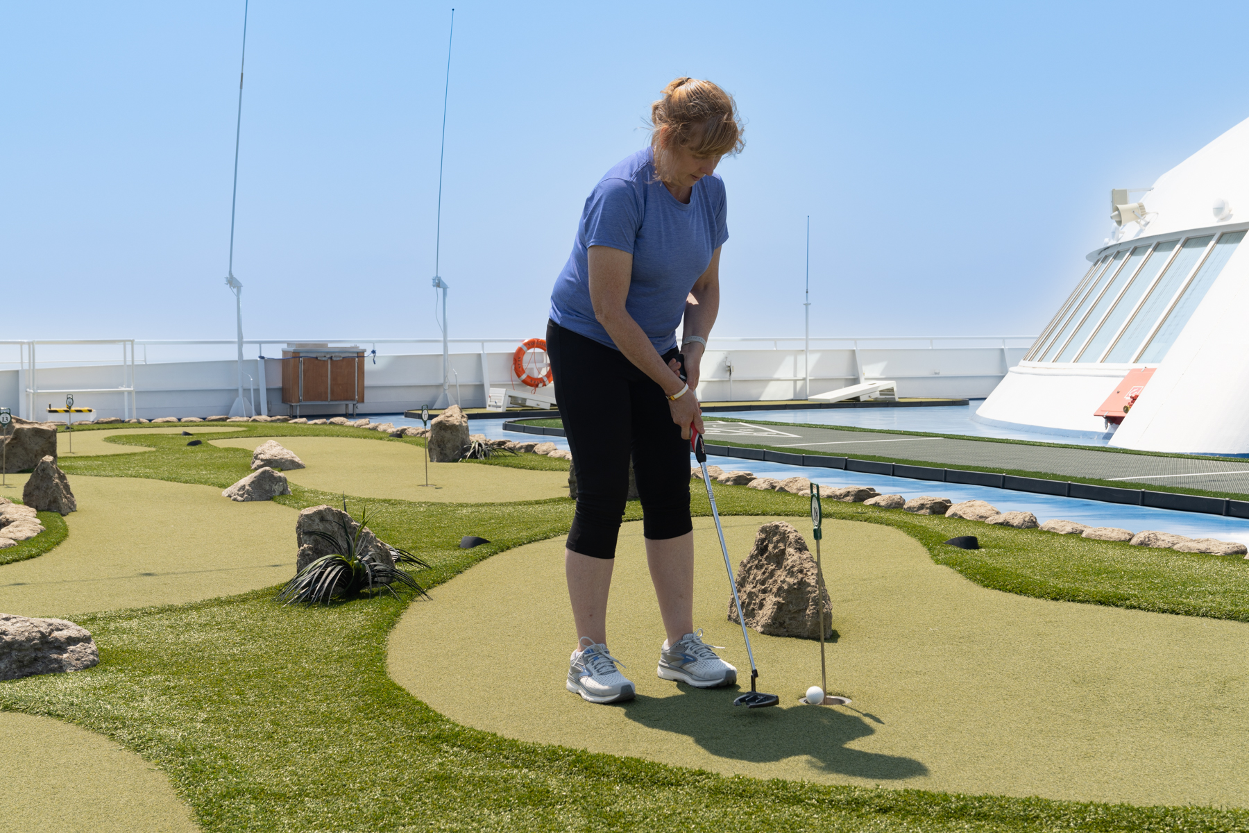 Andrea playing mini-golf.
