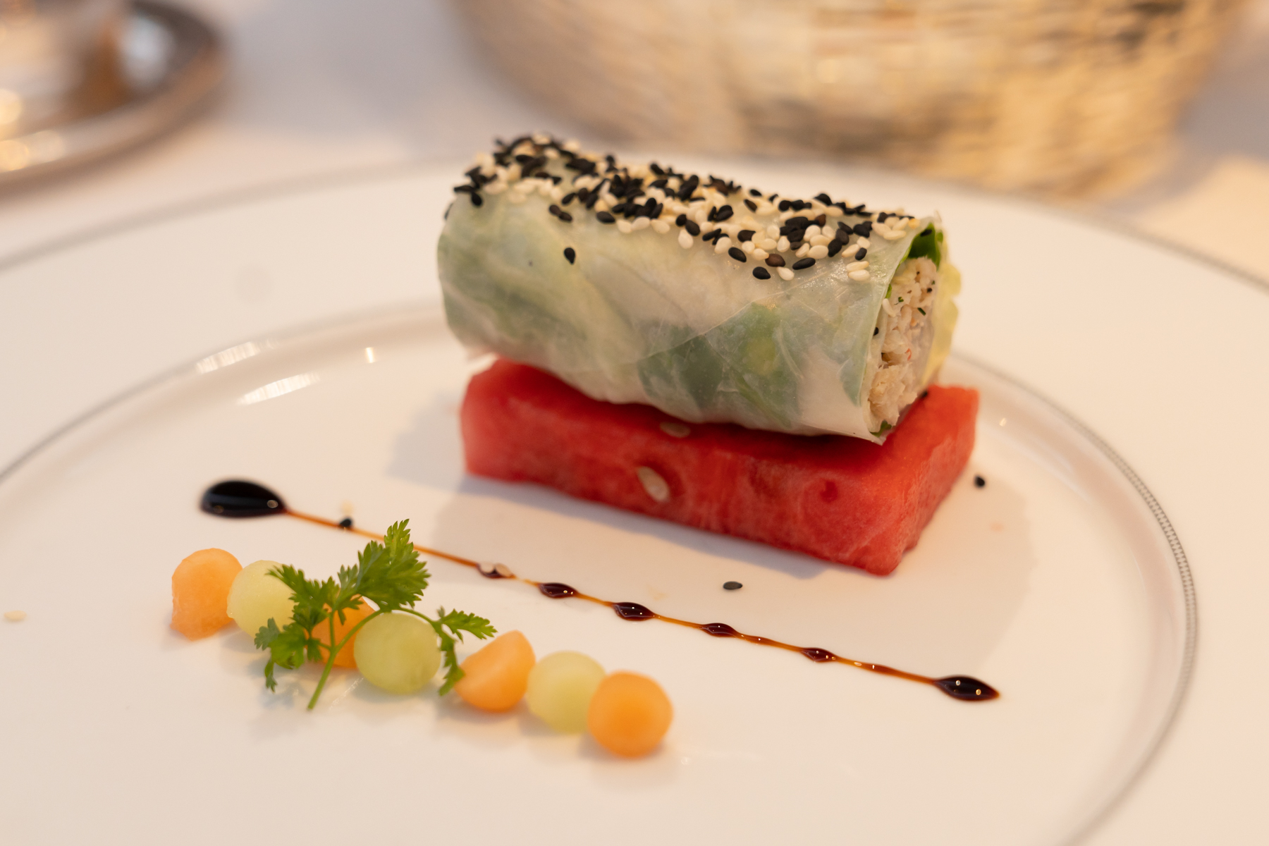 Snow crab summer roll with yuzu and sesame, on pickled watermelon.