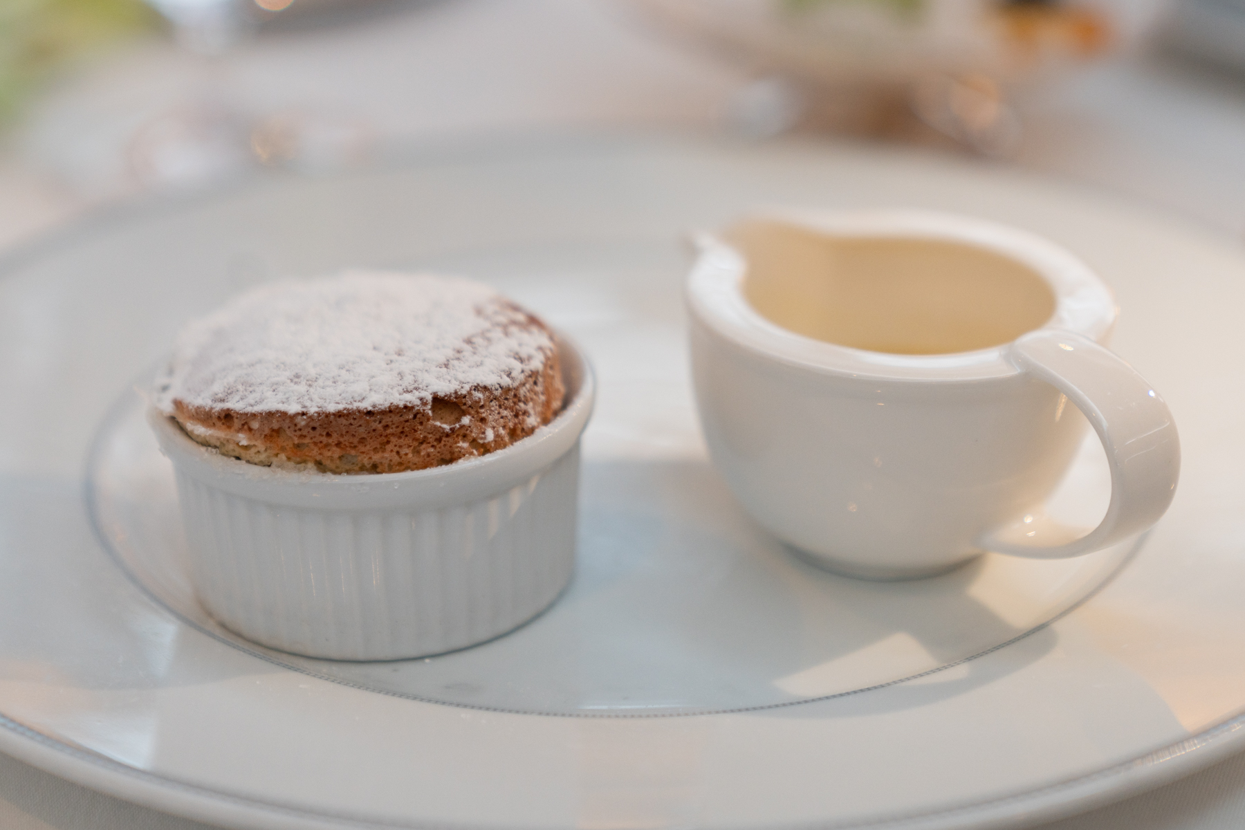 Pistachio soufflé with white chocolate sauce.