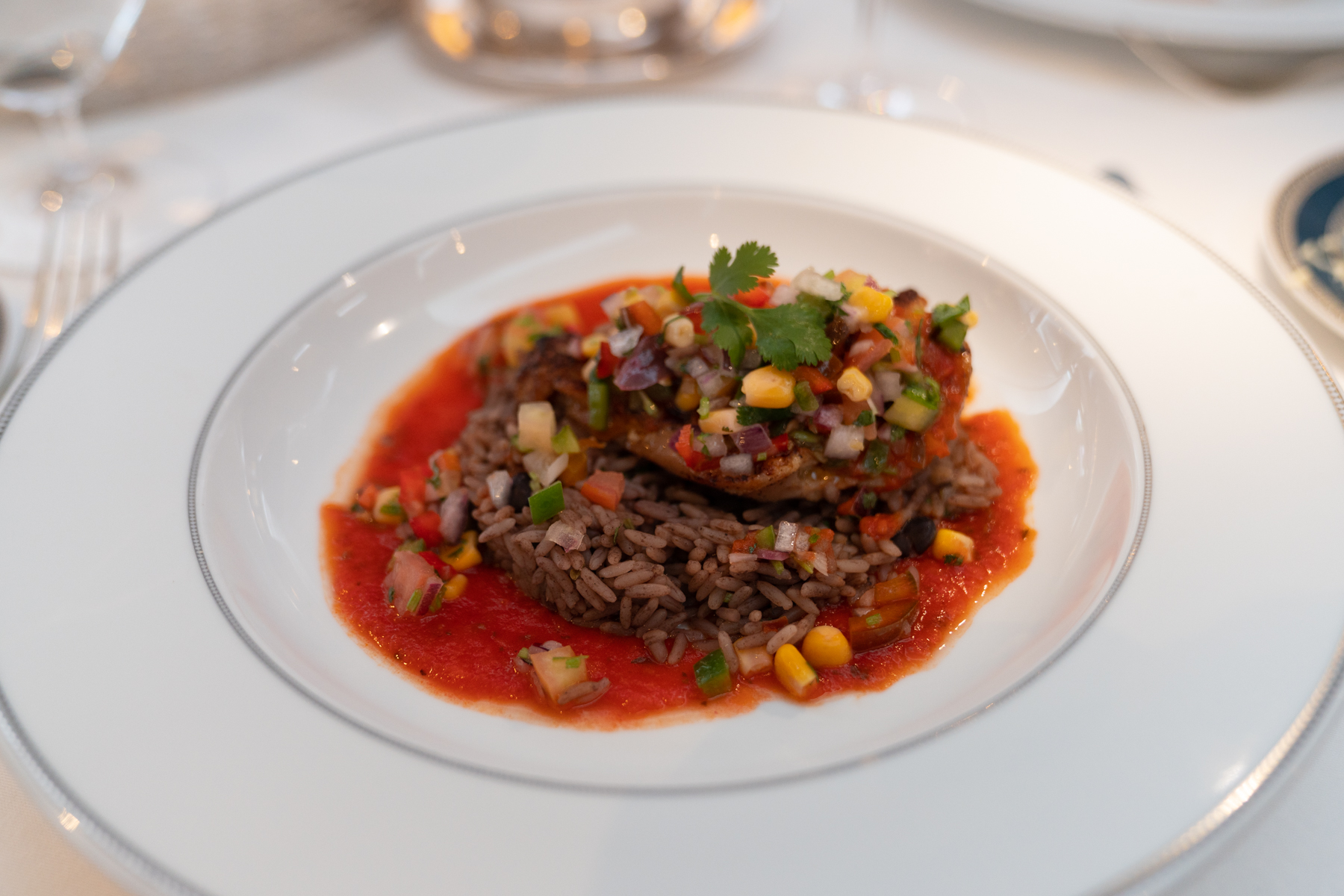 Jerk marinated slow-cooked chicken breast with black bean rice and corn salsa.