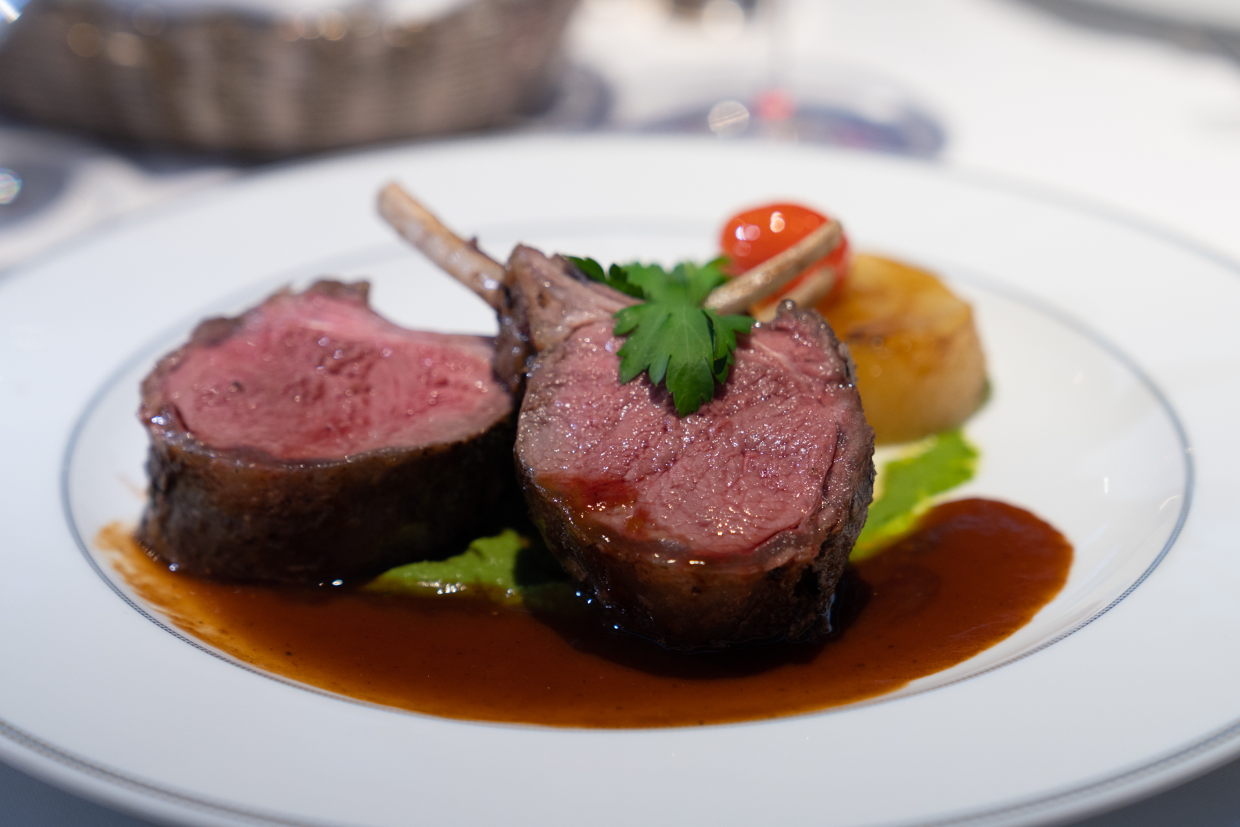 Rosemary and garlic roasted lam rack with Spring pea min purée, fondant potato, and natural jus.