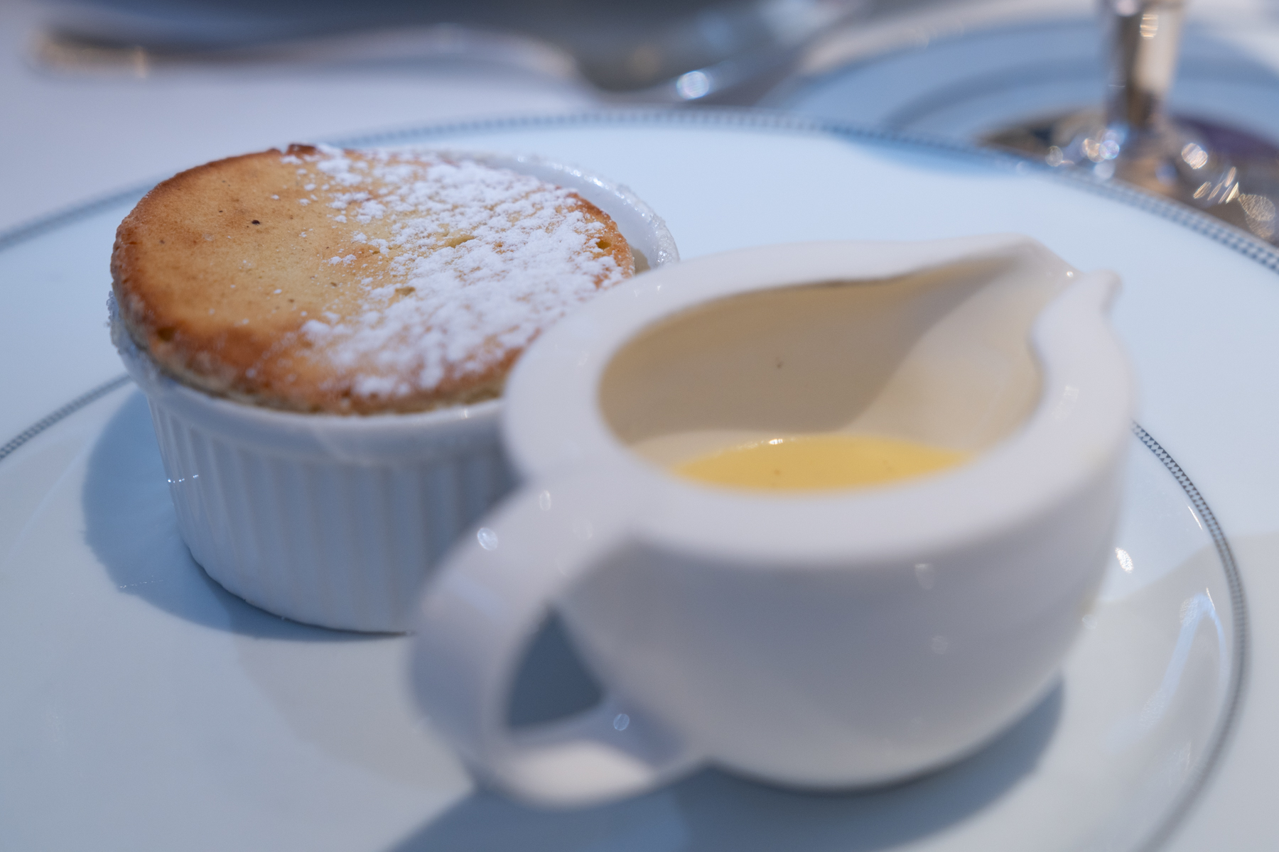 Pistachio soufflé with white chocolate sauce.