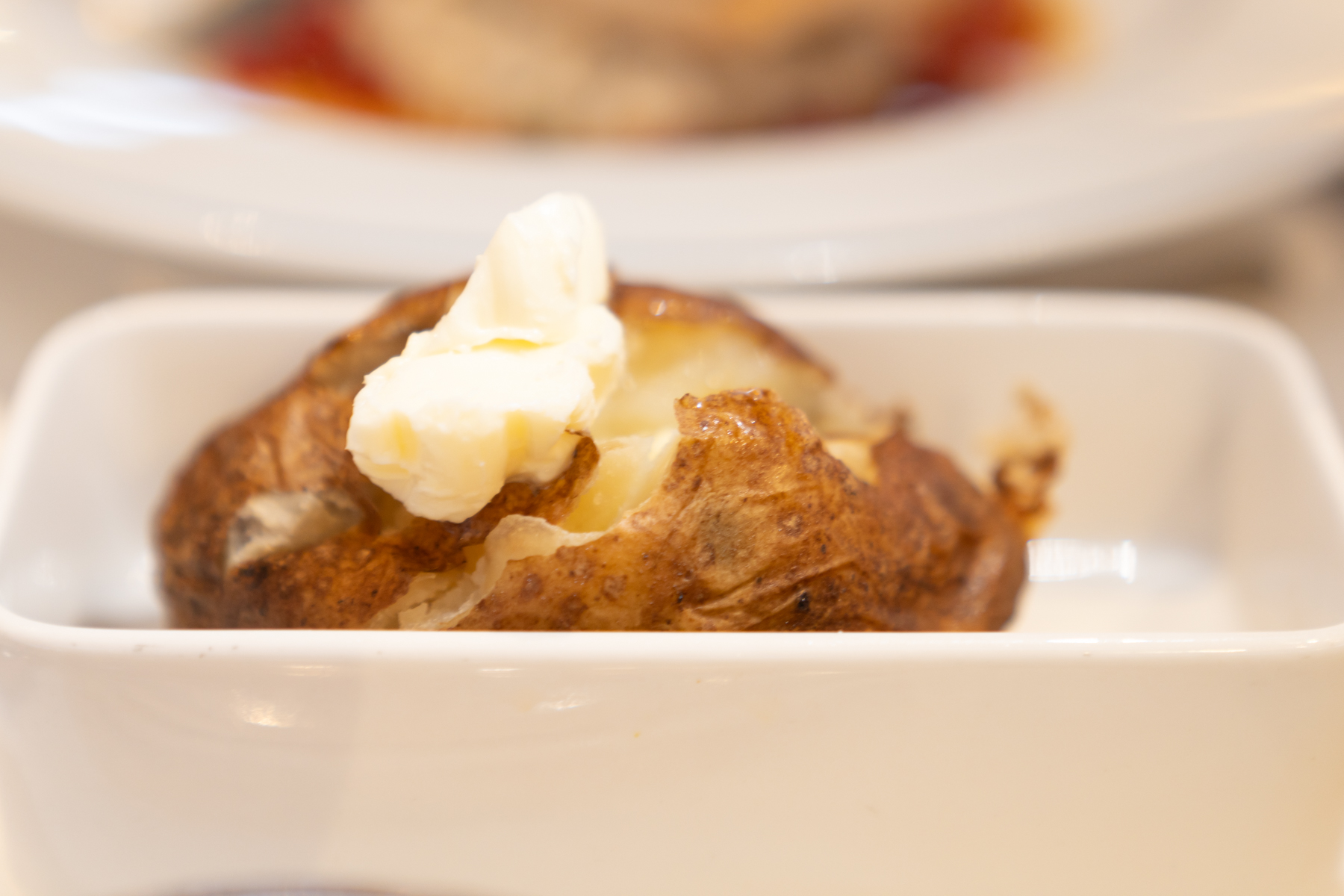 Baked potato with sour cream.