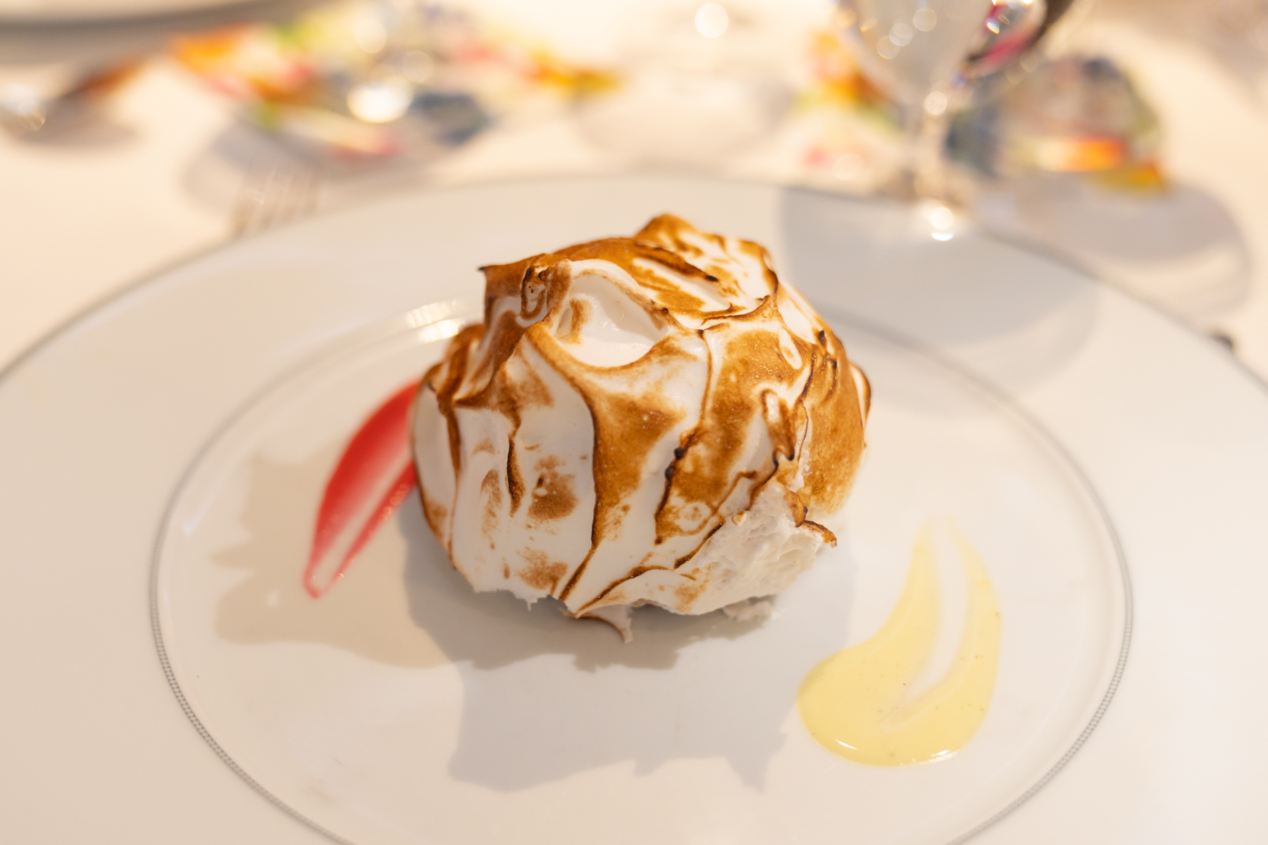 Baked Alaska with raspberry and vanilla sauce.