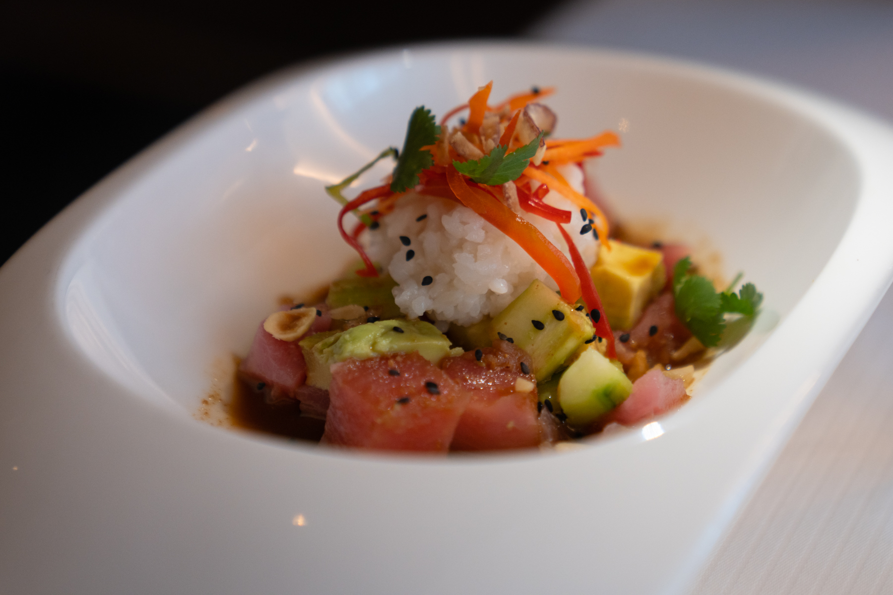 Ahi tuna and avocado poke with soy and sesame dressing, macadamia nuts, and sushi rice.