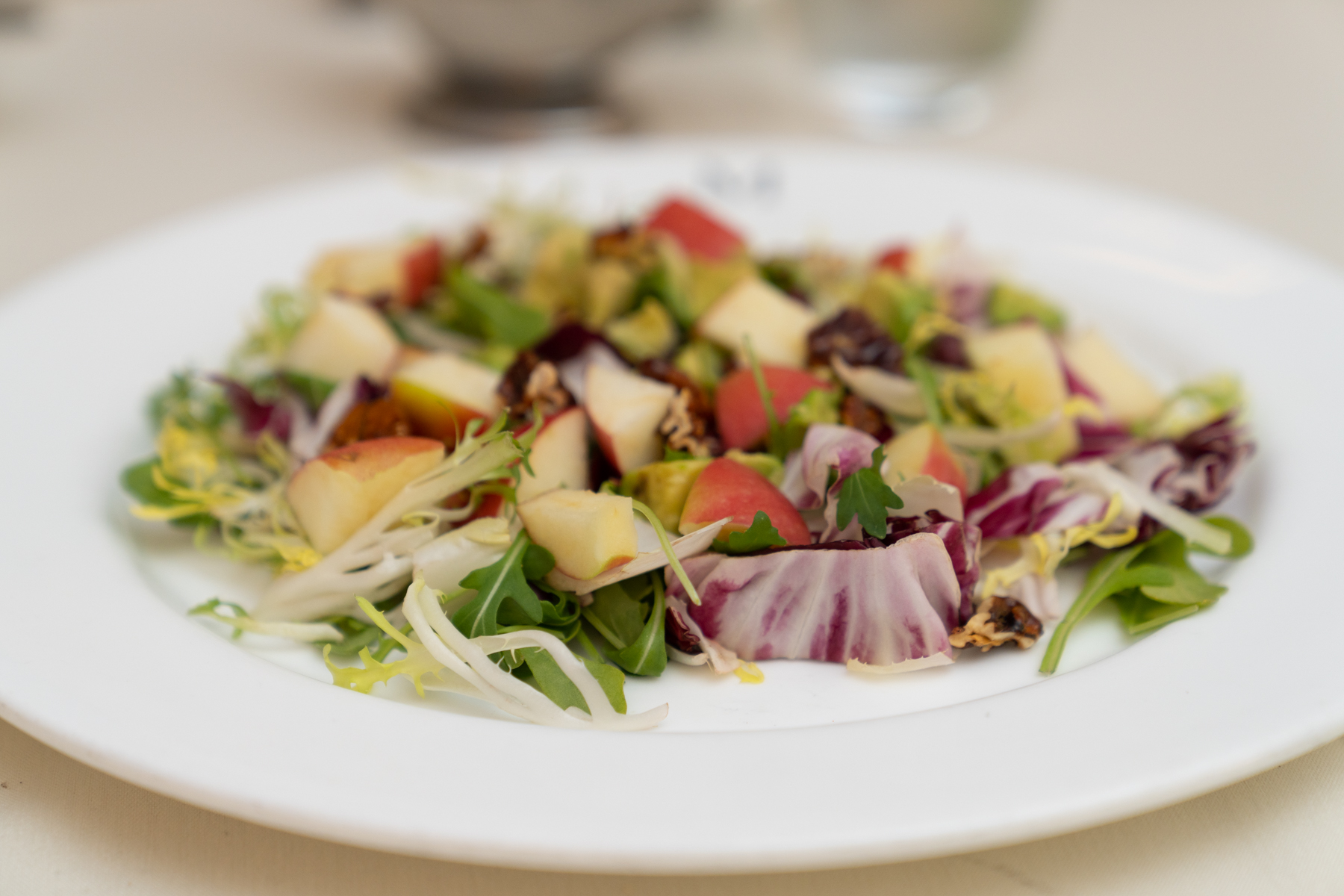 Salad with apple, avocado, and pecans.