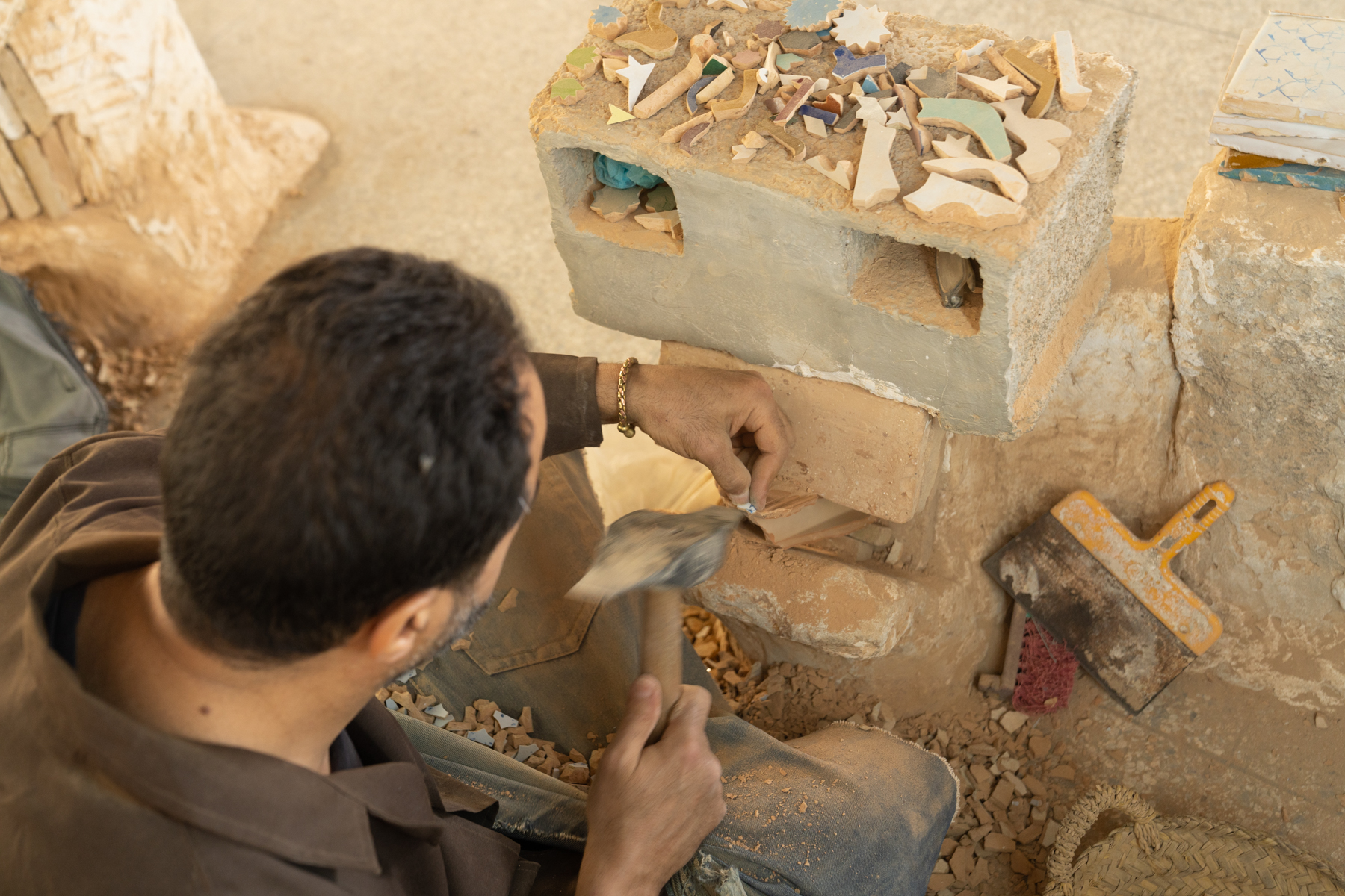 A worker making mosaic tiles.