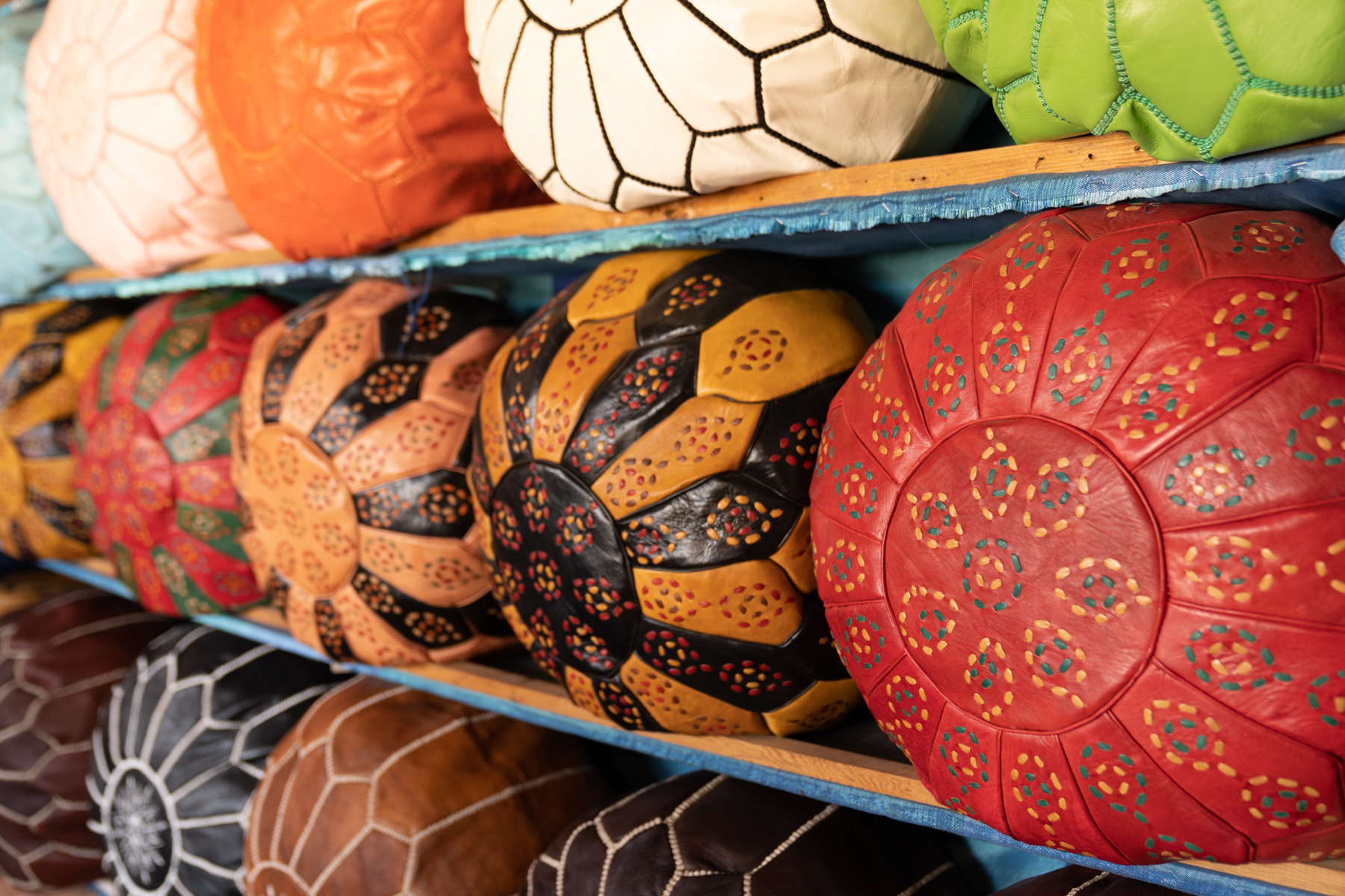 Colorful pouffes for sale in a leather store.