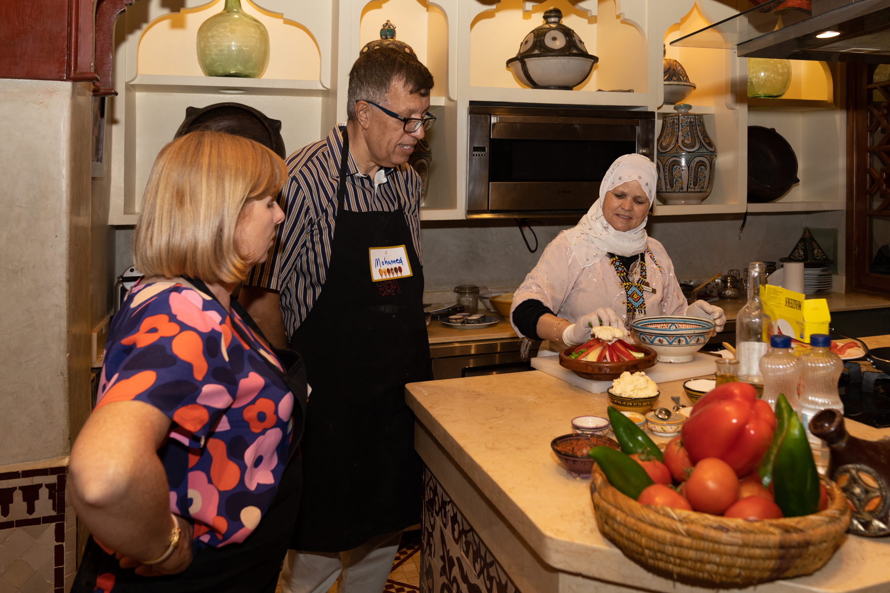 Being shown how to prepare a vegetable tagine.