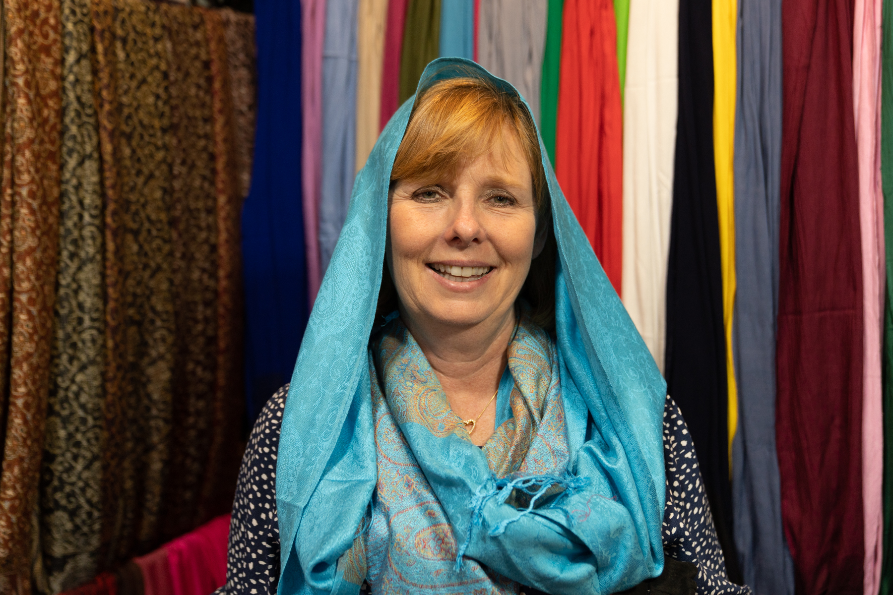 Andrea trying on a scarf.