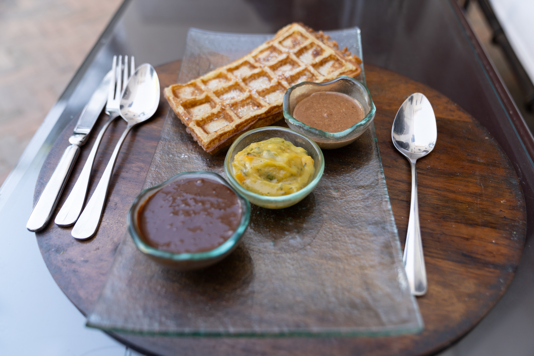 Waffle with chocolate sauce, orange sauce, and argan sauce.