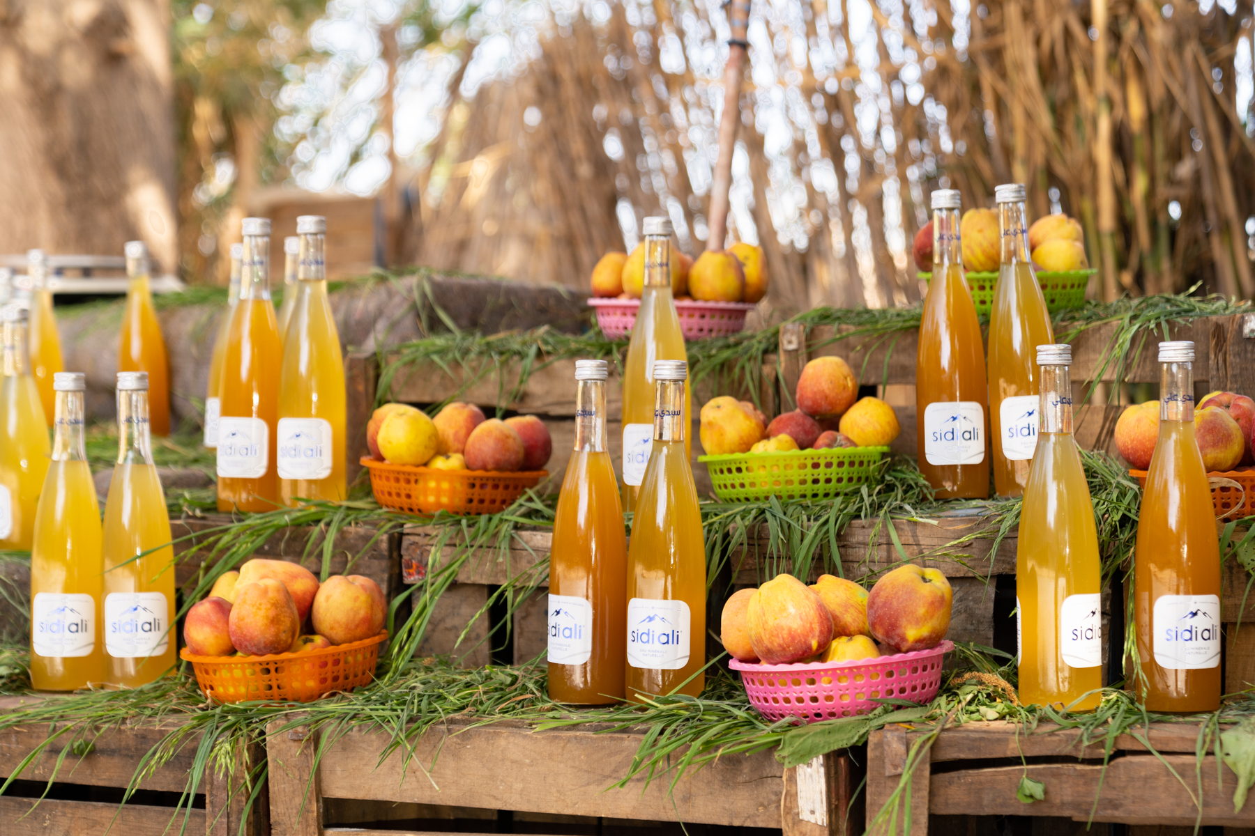 A roadside stand selling apples and apple vinegar.