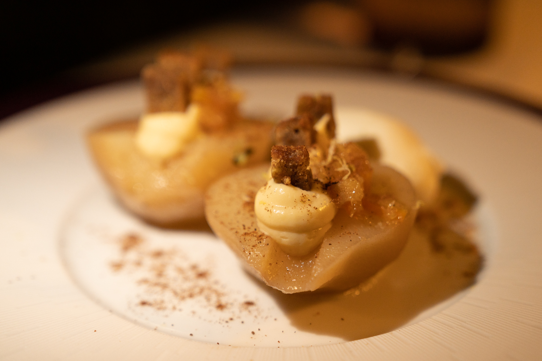 Poached pear with spices, gingerbread, almond, and honey.