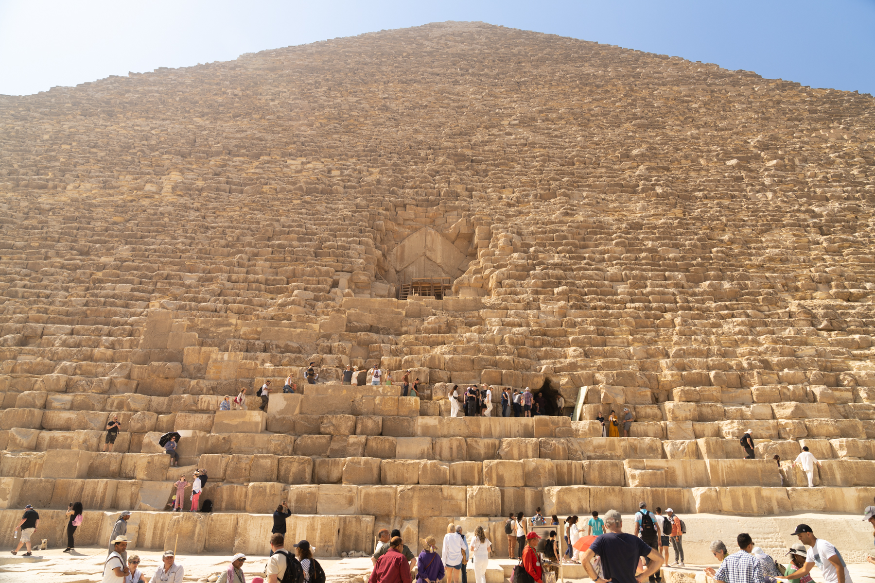 The main entrance to the Great Pyramid is in the middle but access is only available through the much lower Robbers' Tunnel.