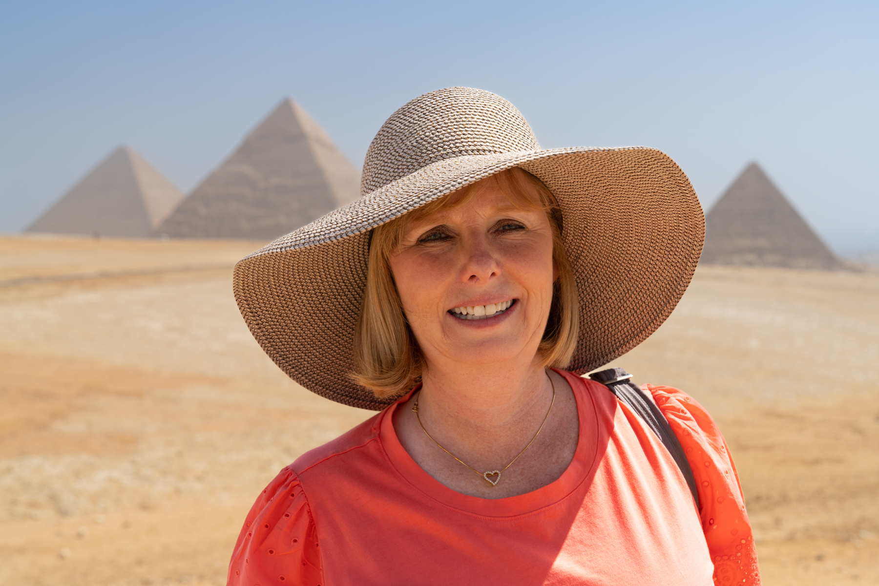 Andrea with the three main pyramids at Giza in the background.