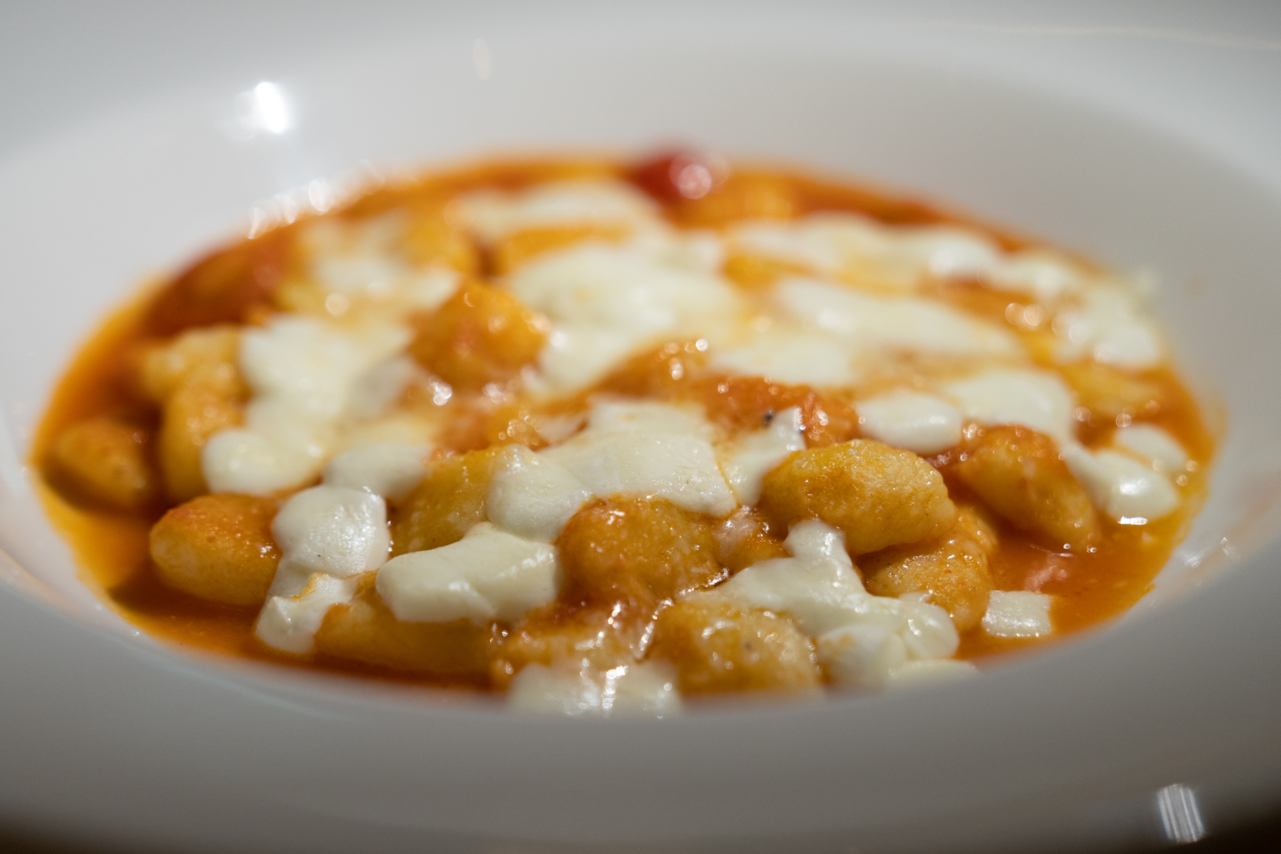 Gnocchi with tomato sauce, basil, and mozzarella cheese gratin.