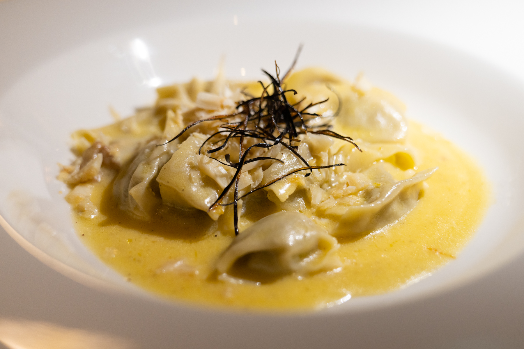 Agnolotti of smoked eggplant with butter-lemon sauce and home-made baked ricotta.