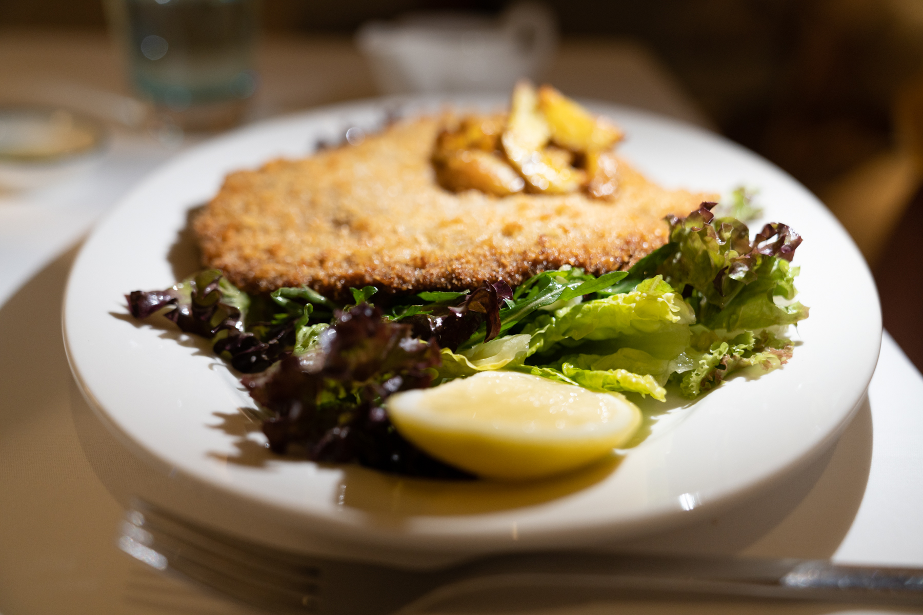 Breaded veal with arugula, cherry tomatoes, and butter-lemon sauce. 