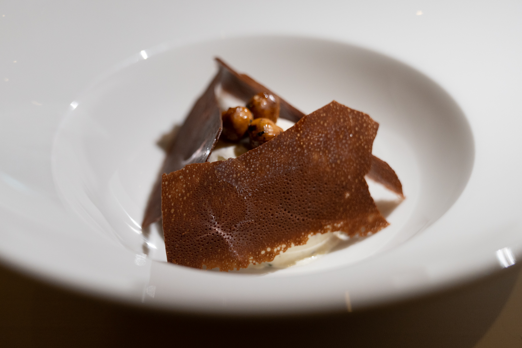 Vanilla semifreddo with roasted hazelnuts, candied orange, and chocolate sauce.