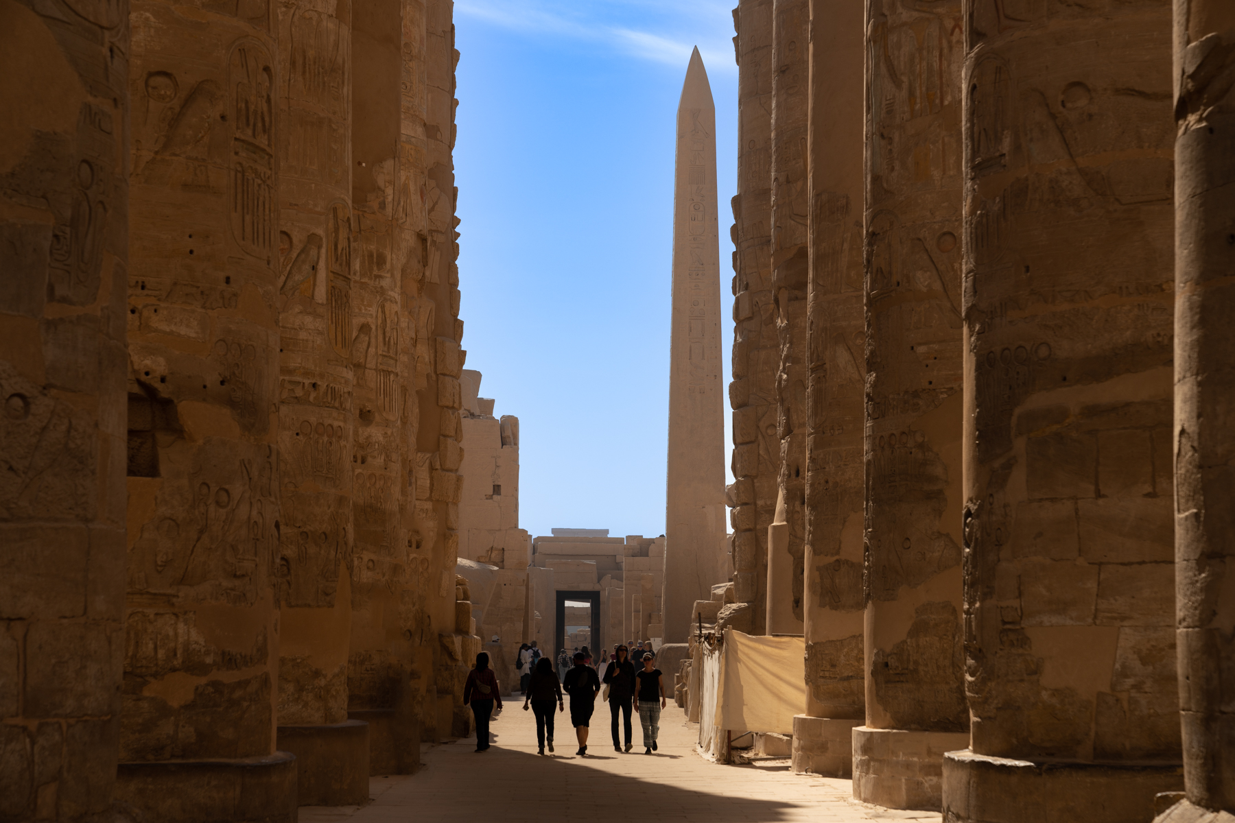Looking through the huge columns at Karnak to the obelisk.
