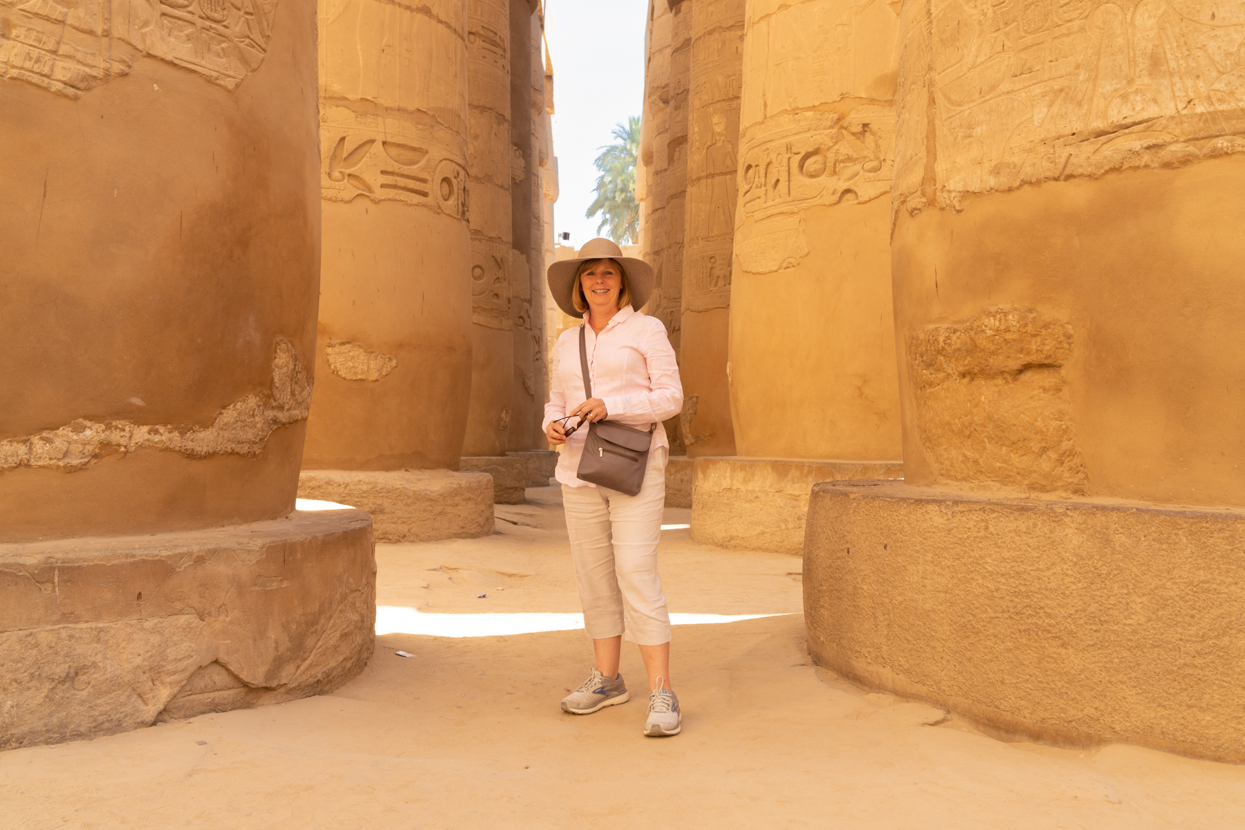 Andrea in between columns in the Great Hypostyle Hall at Karnak.