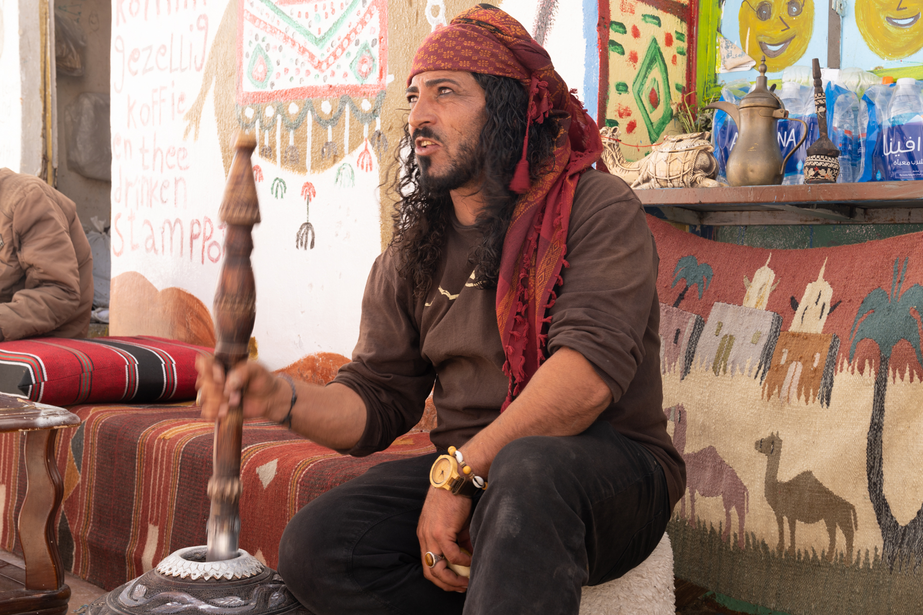 Hany grinding coffee in the mehbash.
