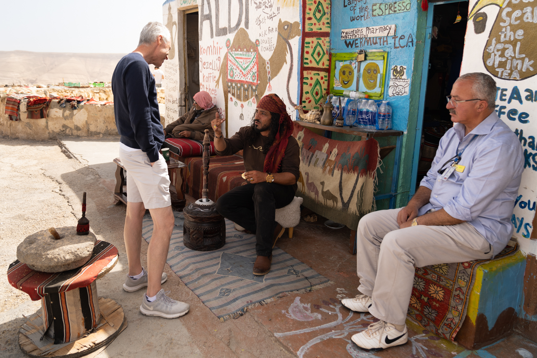 Keith learning about the rhythm of coffee grinding from Hany.