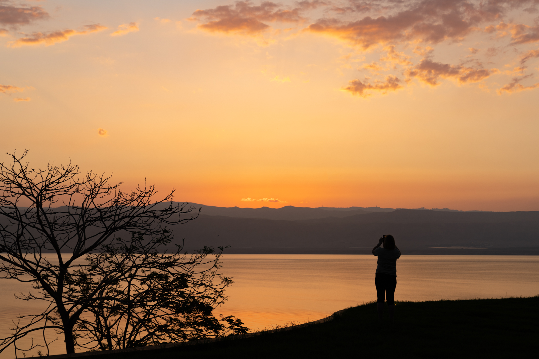 Andrea taking a photo of the sunset over the Dead Sea.