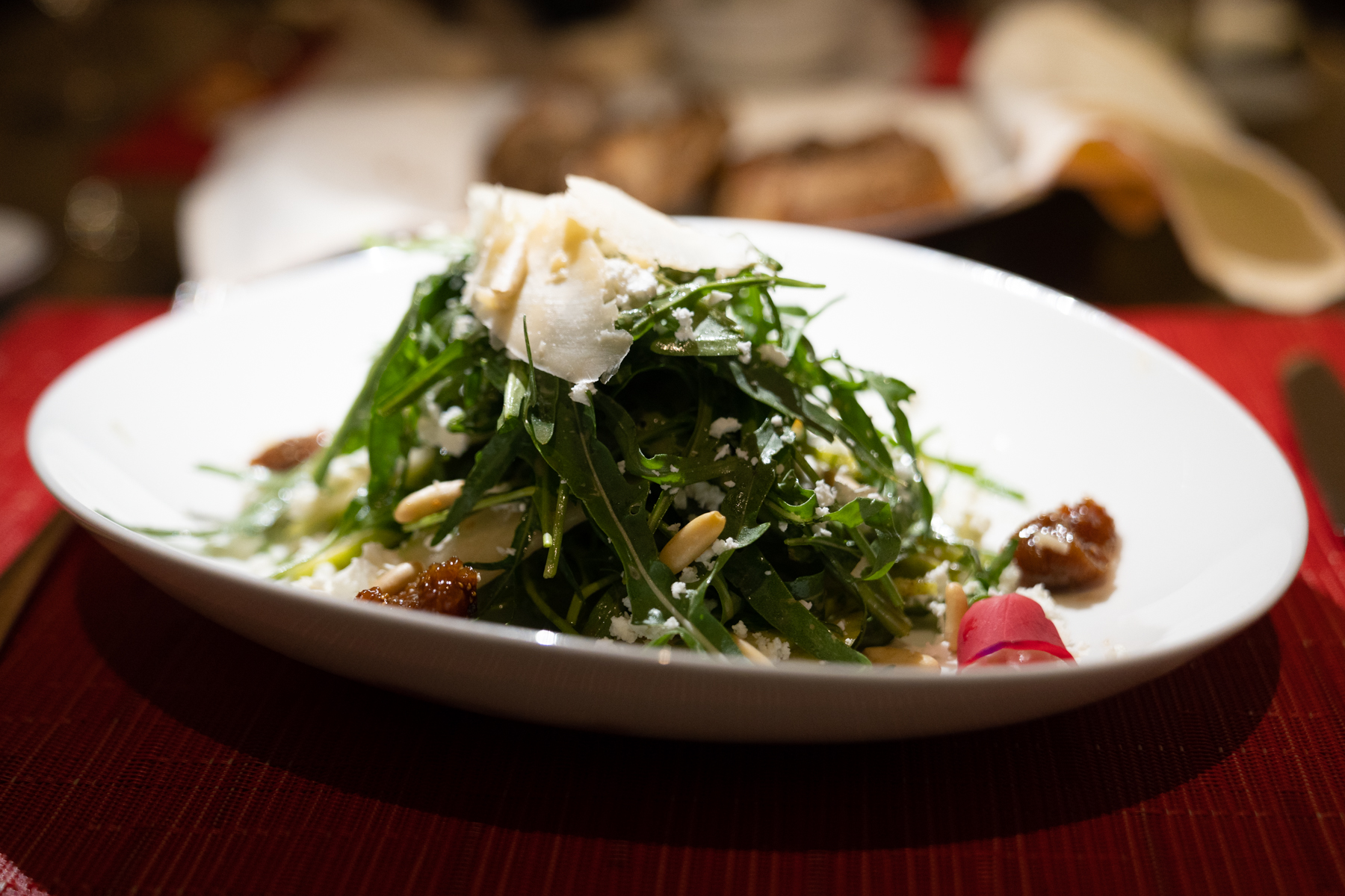 Salad of arugula, pear, parmesan, pine nuts, and figs.