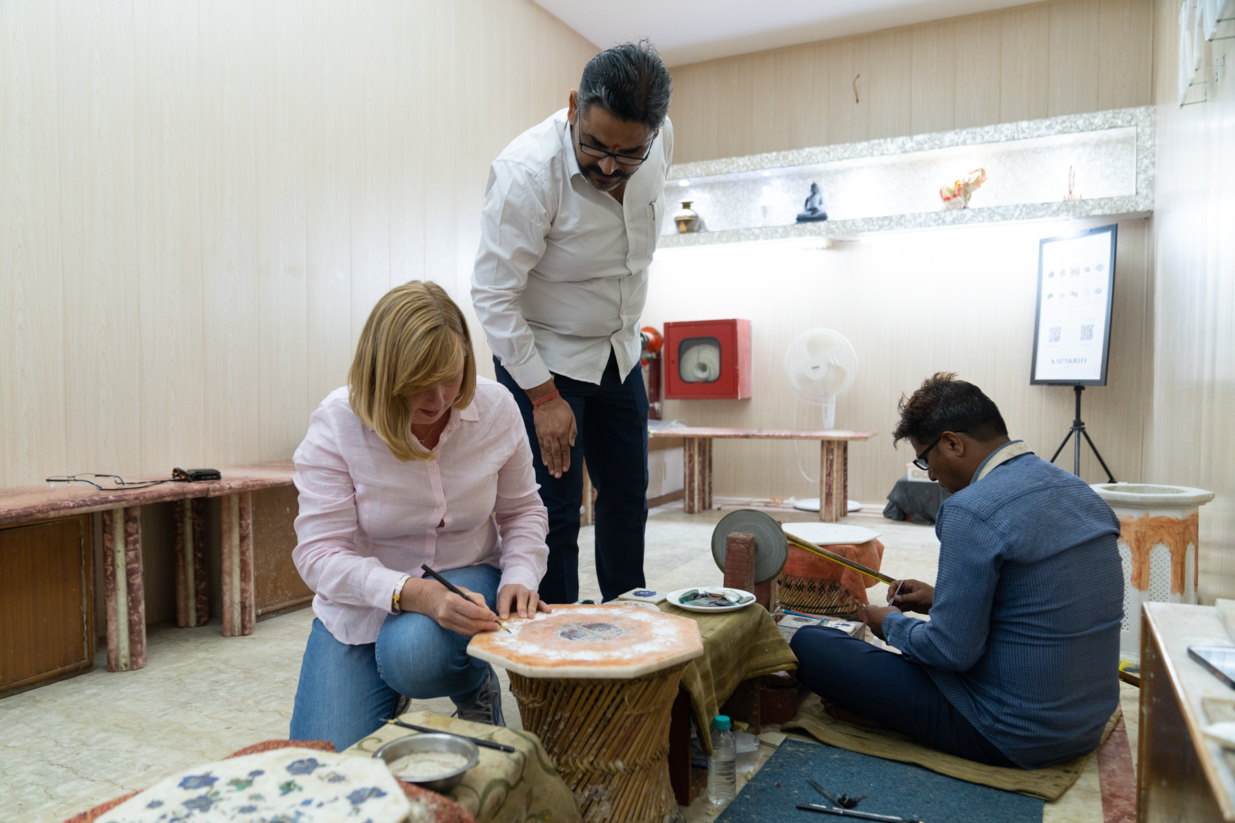 Andrea trying out her carving skills in a piece of marble.
