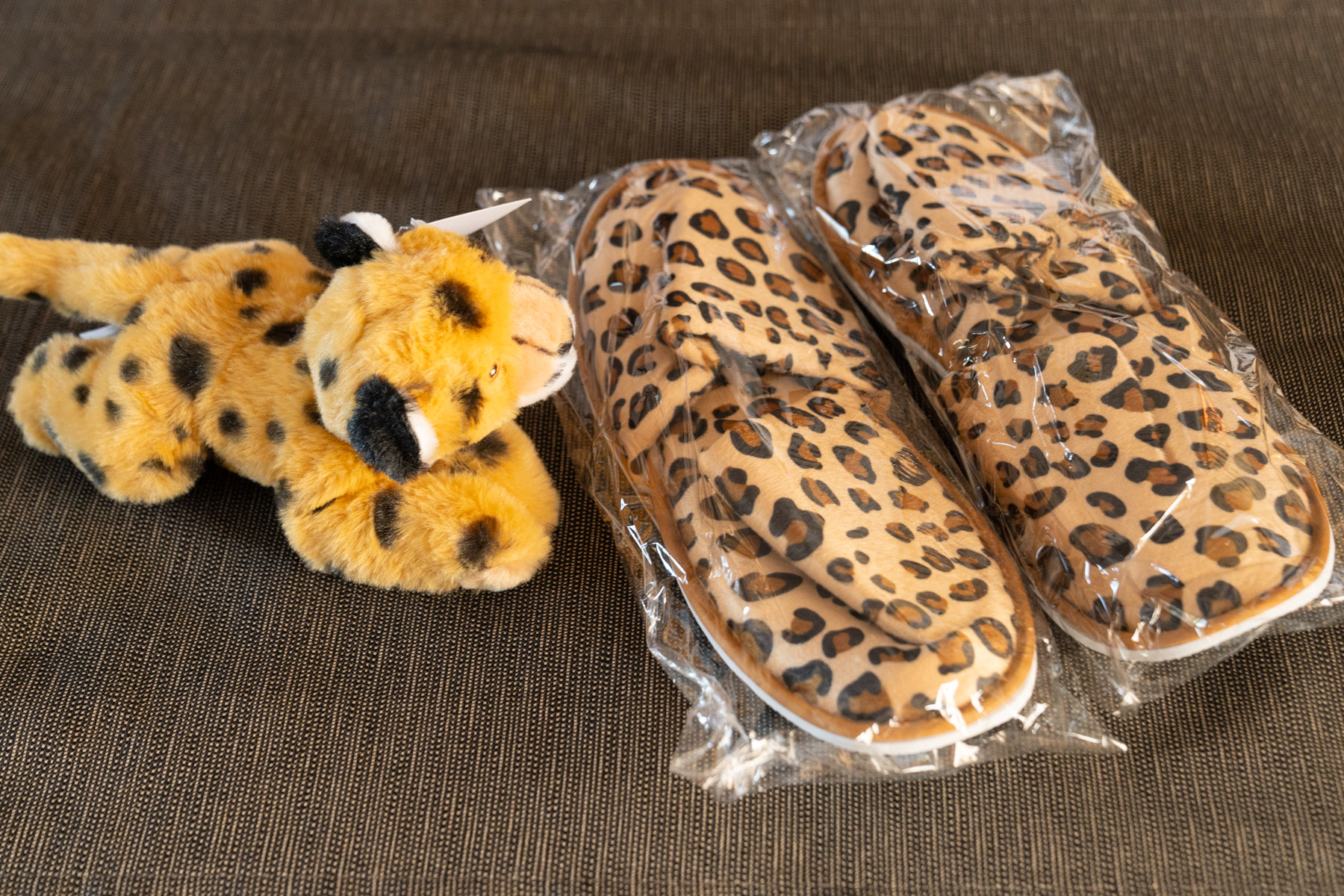 Slippers and soft toy leopard in our room.