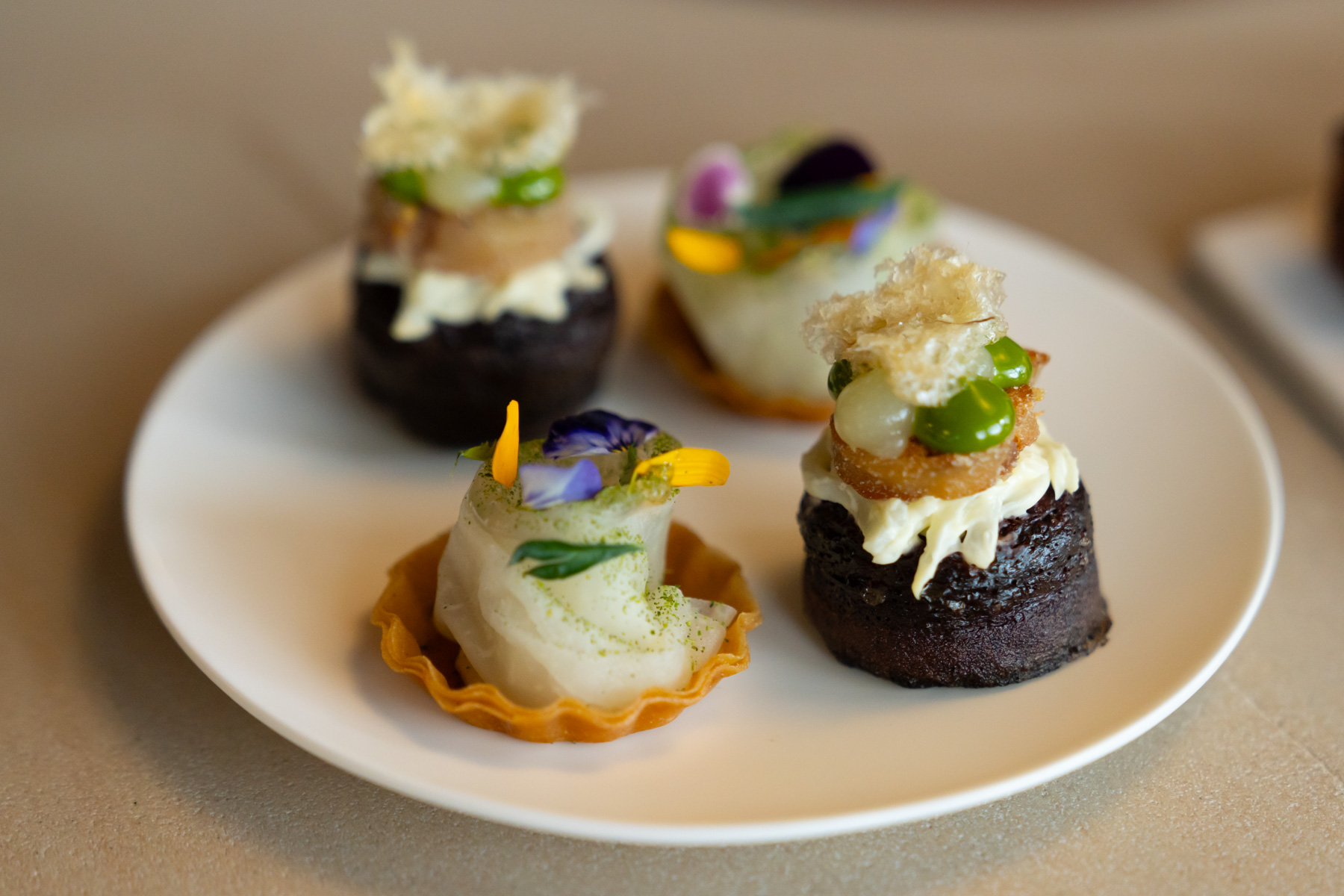 Pigs blood crumpet, pig trotter, turnip, with tart of fermented kohlrabi, hemp seed puree, apple marigold.