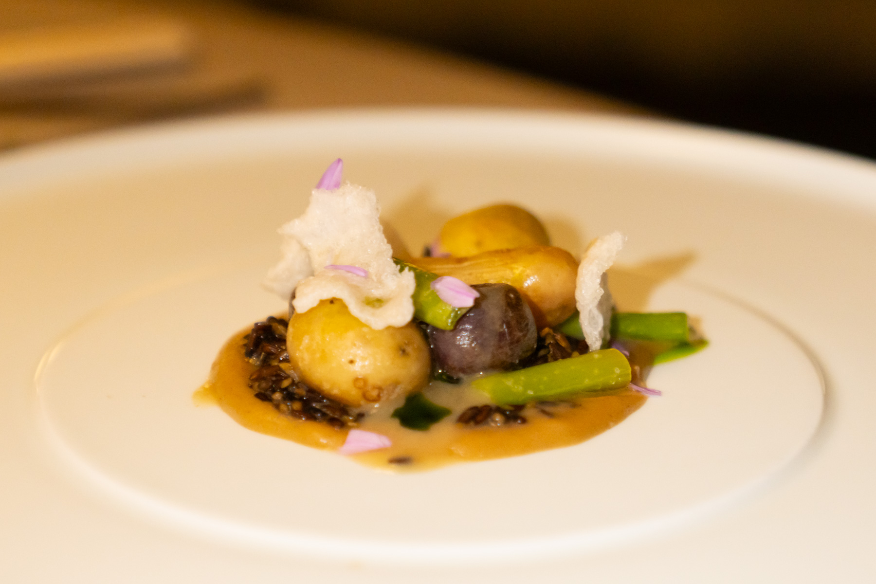 New potatoes, squash, braised wattle seed, smoked potato beurre blanc.