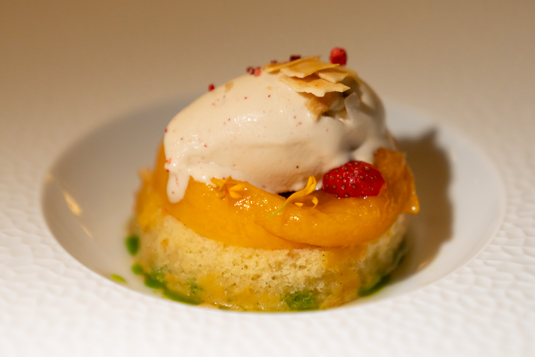 Peaches and cream swiss roll, poached peaches, biscoff ice cream.