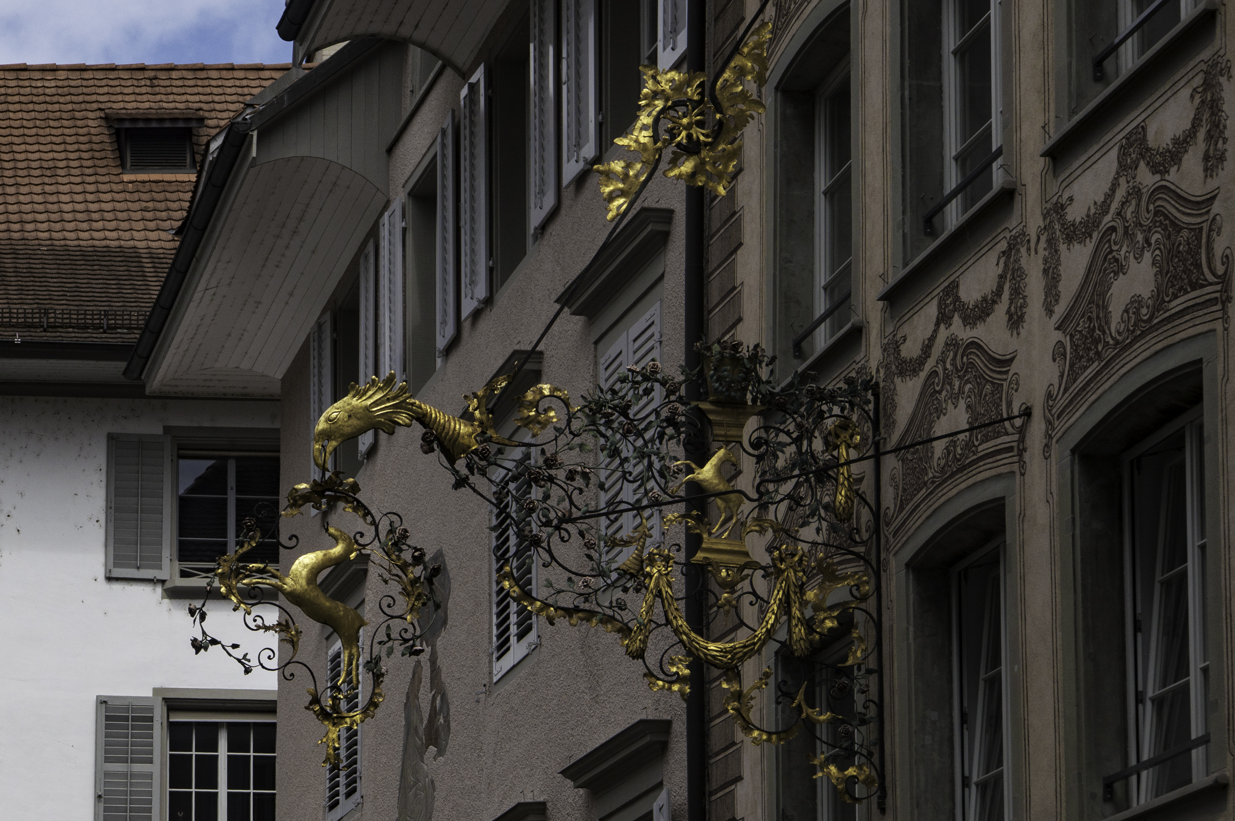 Decorative wrought-iron and gold guild sign in Lucerne’s Old Town.