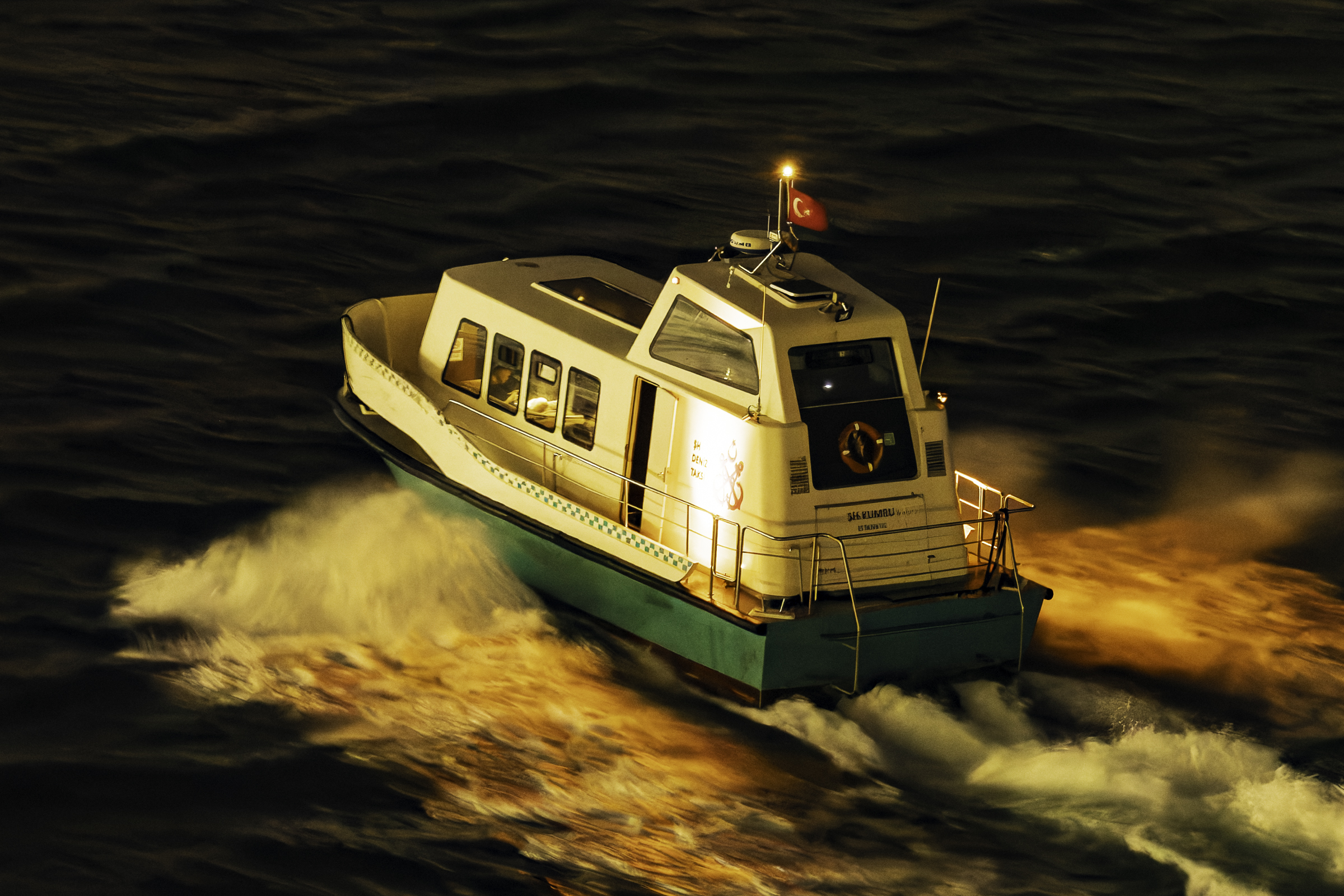 A water taxi going past the ship.