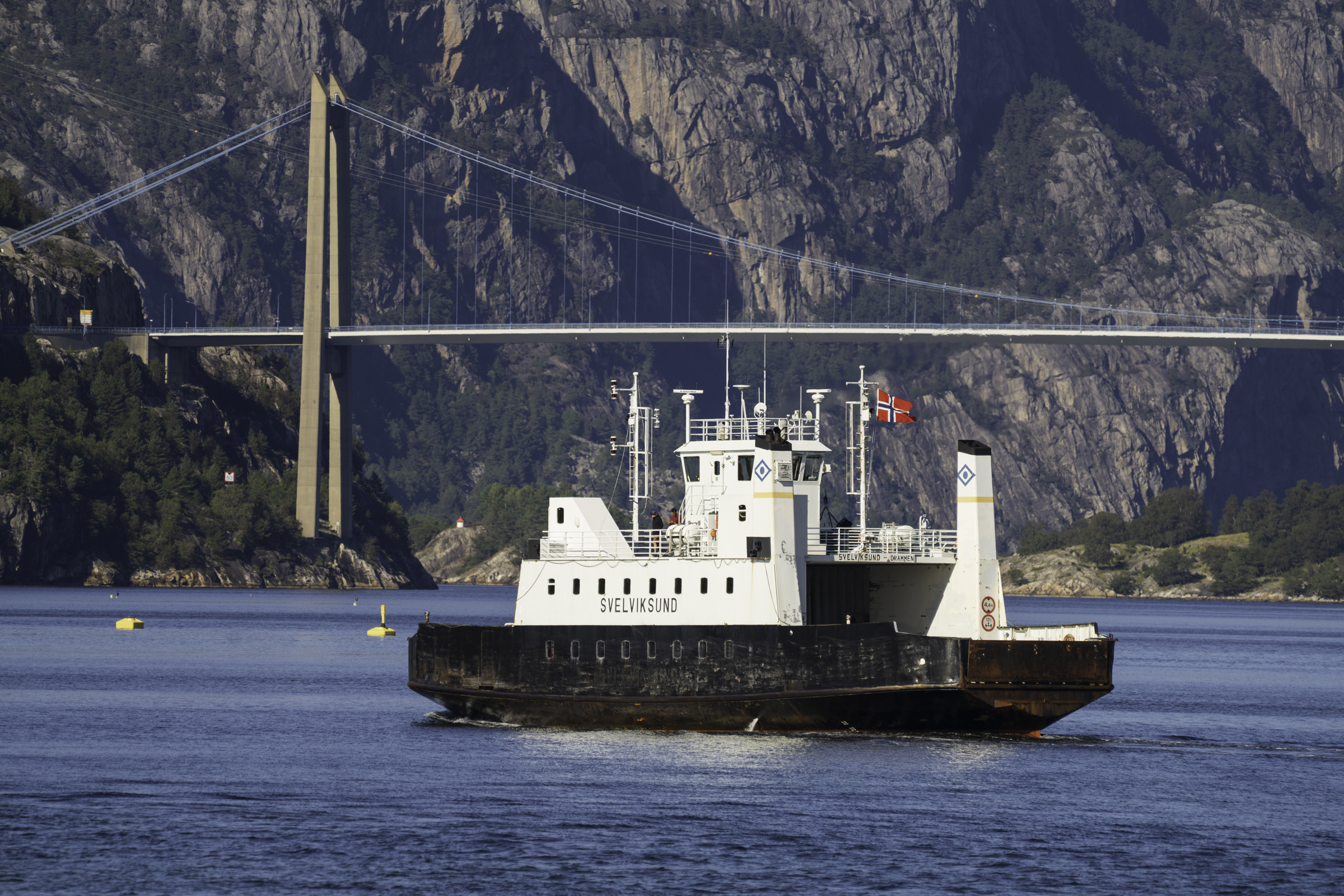 Car carrier on the Lysefjord, with the Lysefjord Bridge in the background.