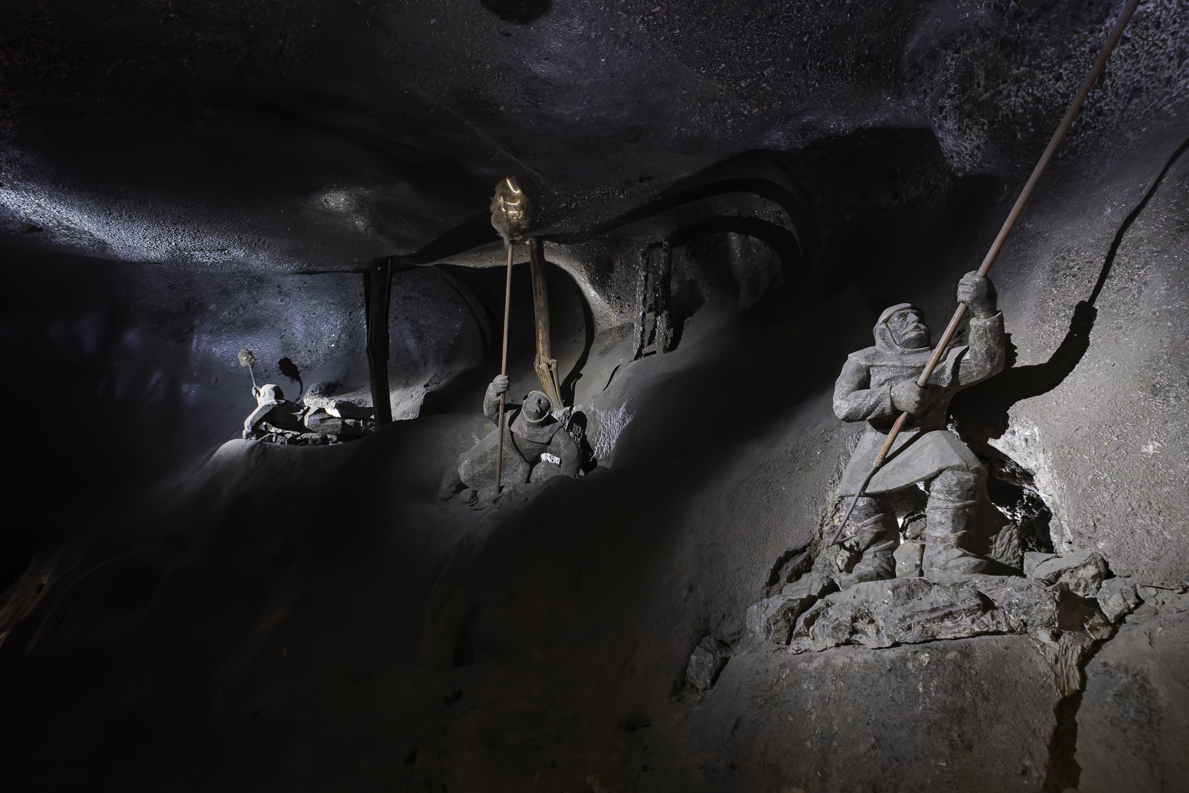 Sculpture depicting miners at work in the Wieliczka Salt Mine, showing how tunnels were excavated by hand using tools and torches.