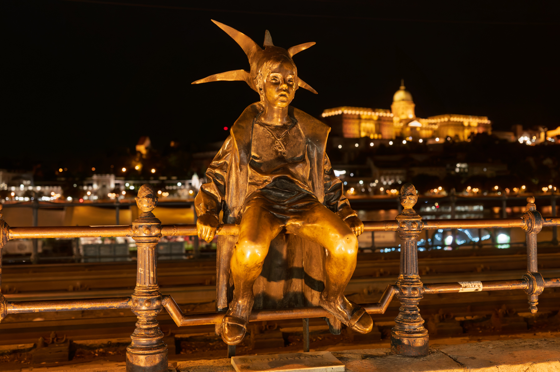 The "Little Princess" statue, with the Buda Castle in the background, in Budapest.