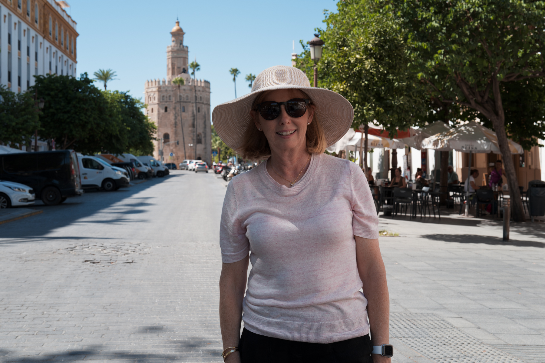 Andrea, on Calle Almirante Lobo with the Torre del Oro in the background, in Seville.