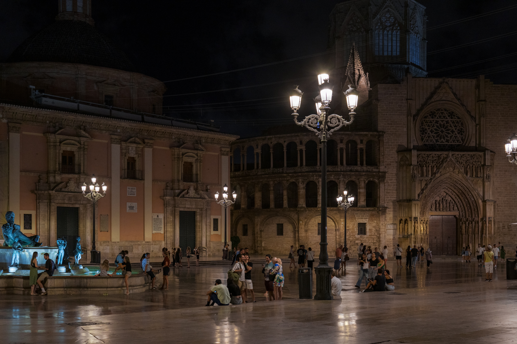 People enjoying the evening in Plaza de la Virgen in Valencia.