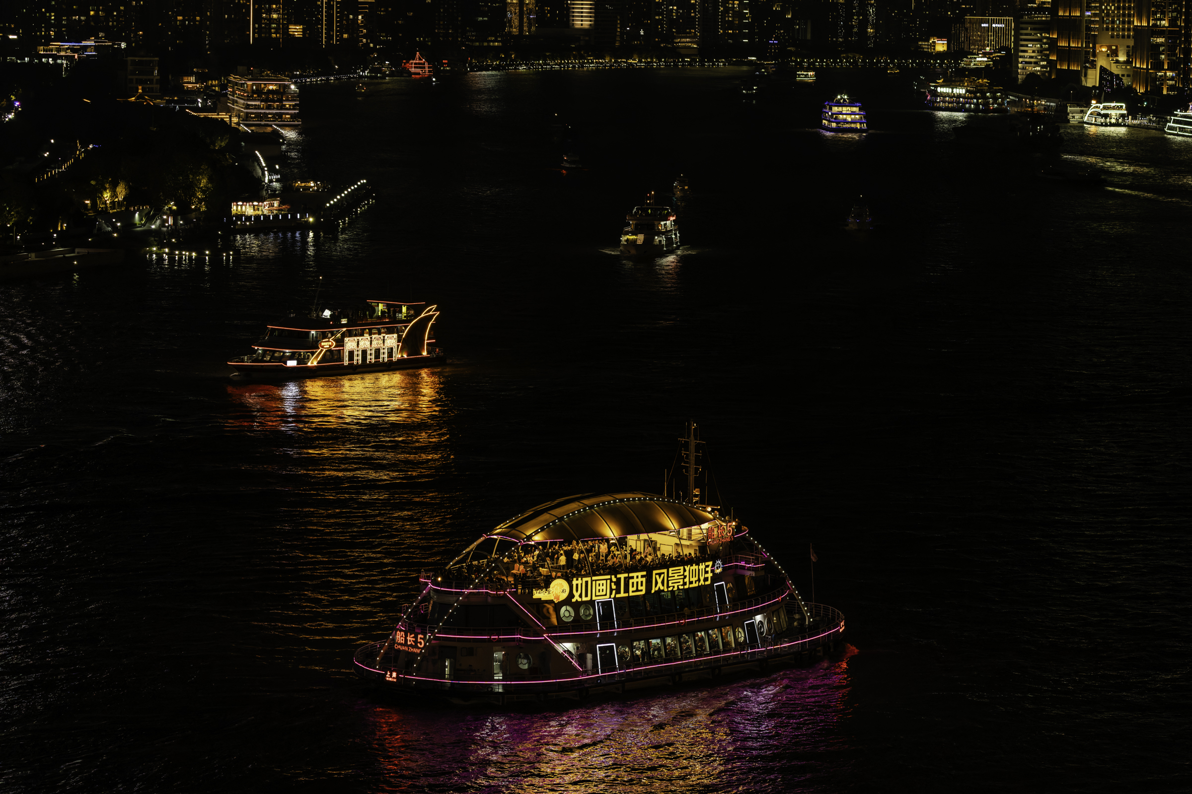 Boats on the Huangpu River in Shanghai .