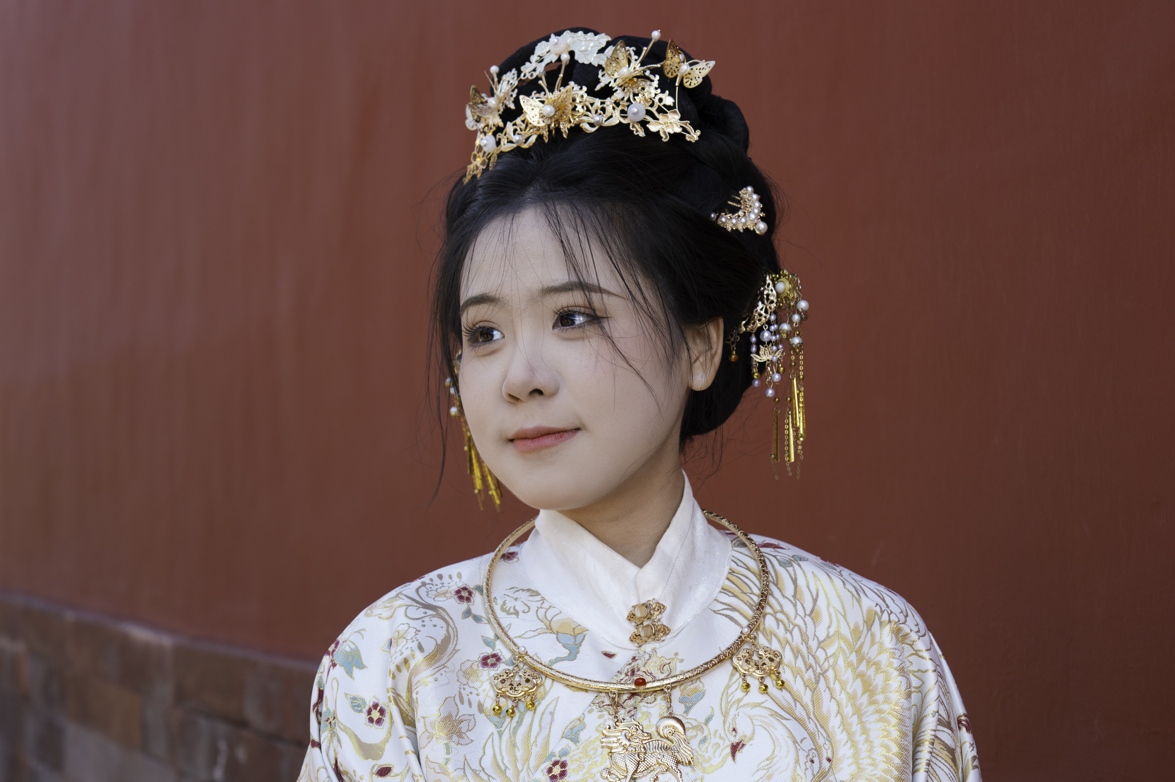 Young girl in traditional dress in the Forbidden City, Beijing.